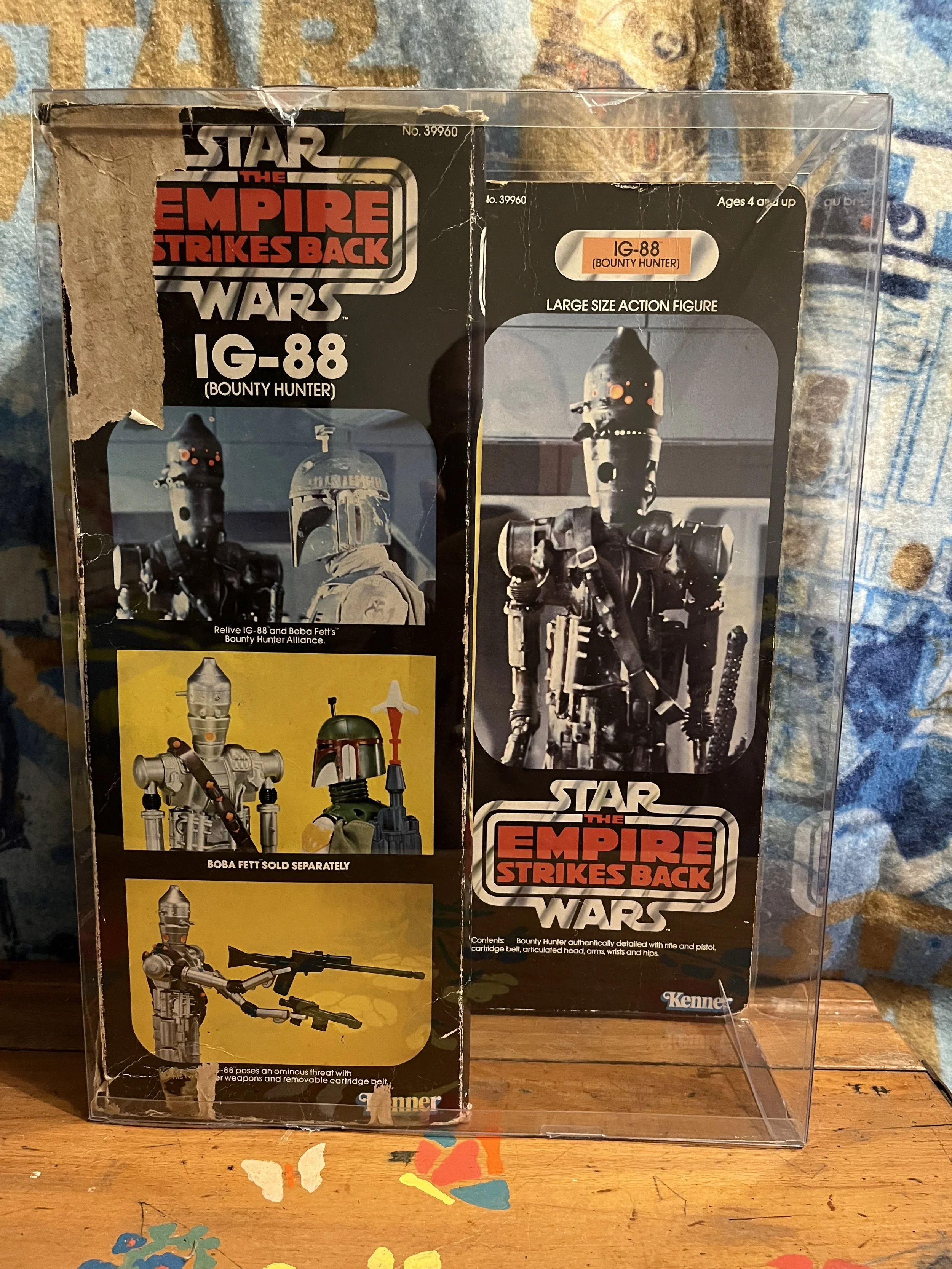 Vintage Kenner boxed Star Wars vintage large sized action figure  IG-88 Bounty Hunter and Boba Fett, with a plastic display case over the box.