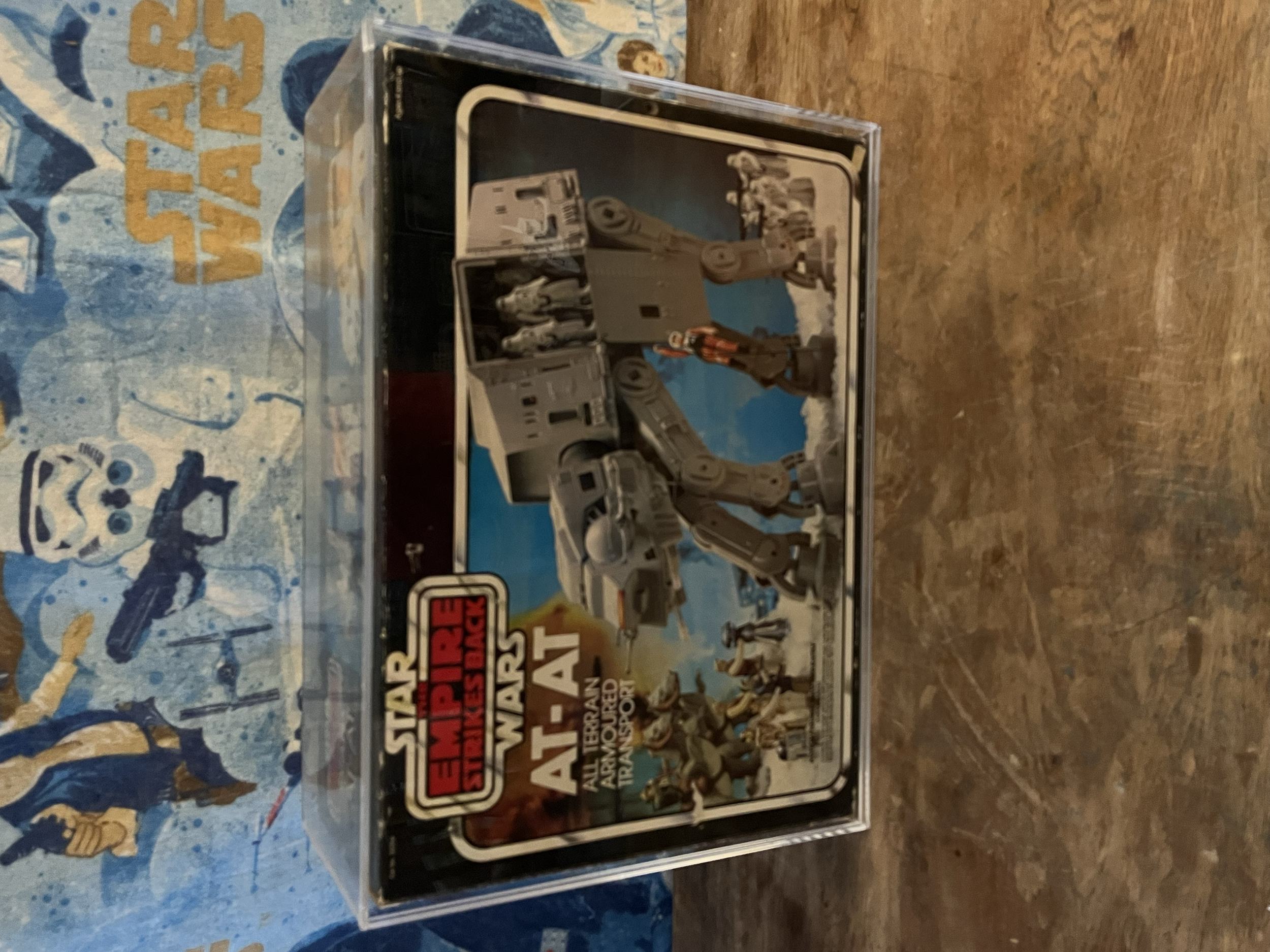 A boxed set of Star Wars review magazines, featuring a picture of classic Star Wars characters on the front, including an AT-AT Walker and other vehicles, with part of a blue background that has yellow and white graphic elements.