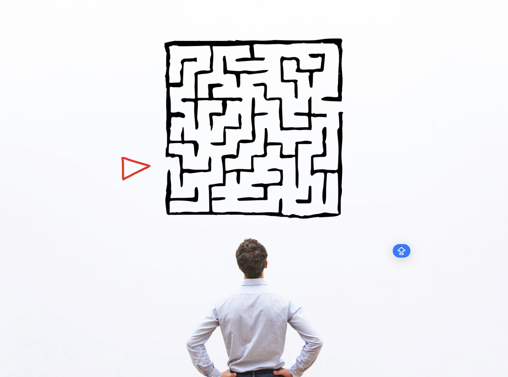 A man in a suit stands with hands on hips, facing a white wall, looking at a large maze drawn on the wall with a red triangle pointing toward it.