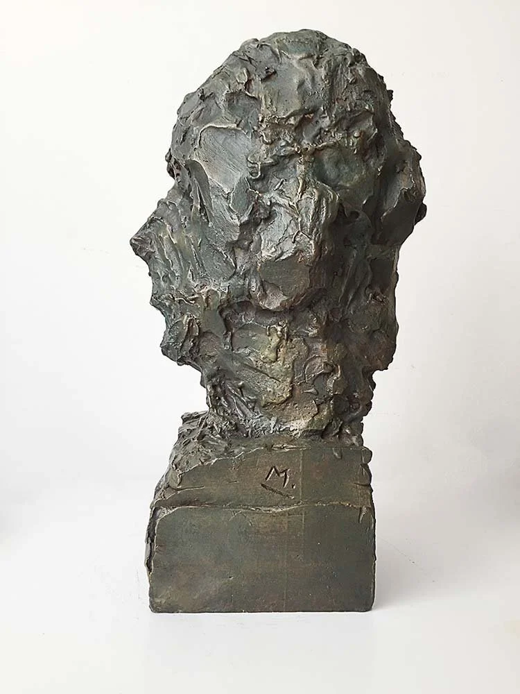 Bronze bust sculpture of a person's head and shoulders with rough texture on a rectangular base, 40 cm, 2015