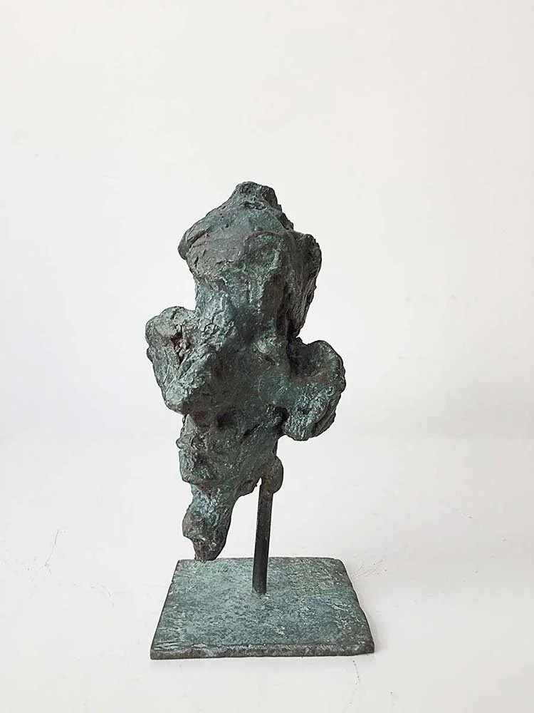 Bronze mask sculpture of a human face profile with a rough, abstract texture on a square base, 22 cm, 2015