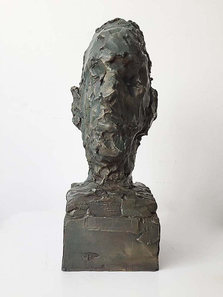 Bronze bust sculpture of a person's head and shoulders with rough texture on a rectangular base, 40 cm, 2015