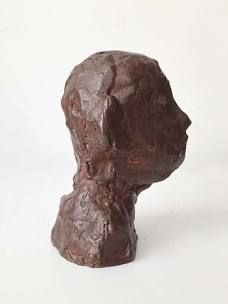 A small, rough-textured, dark-colored bronze sculpture, 12 cm, 2015