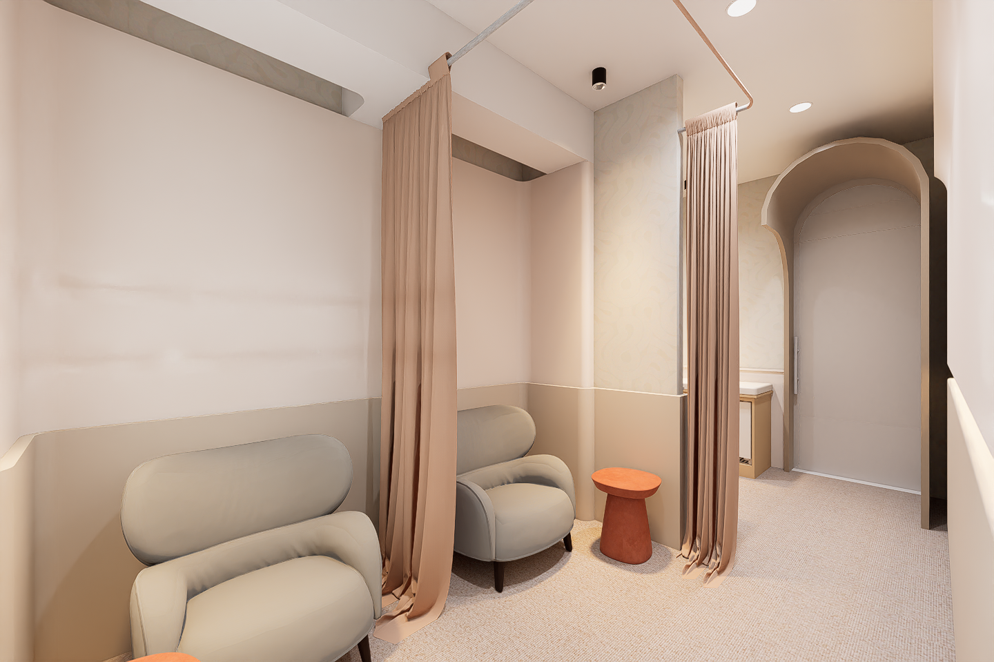 A room with two modern beige armchairs and two small orange side tables, separated by beige curtains, in a softly lit space with neutral walls and carpet.