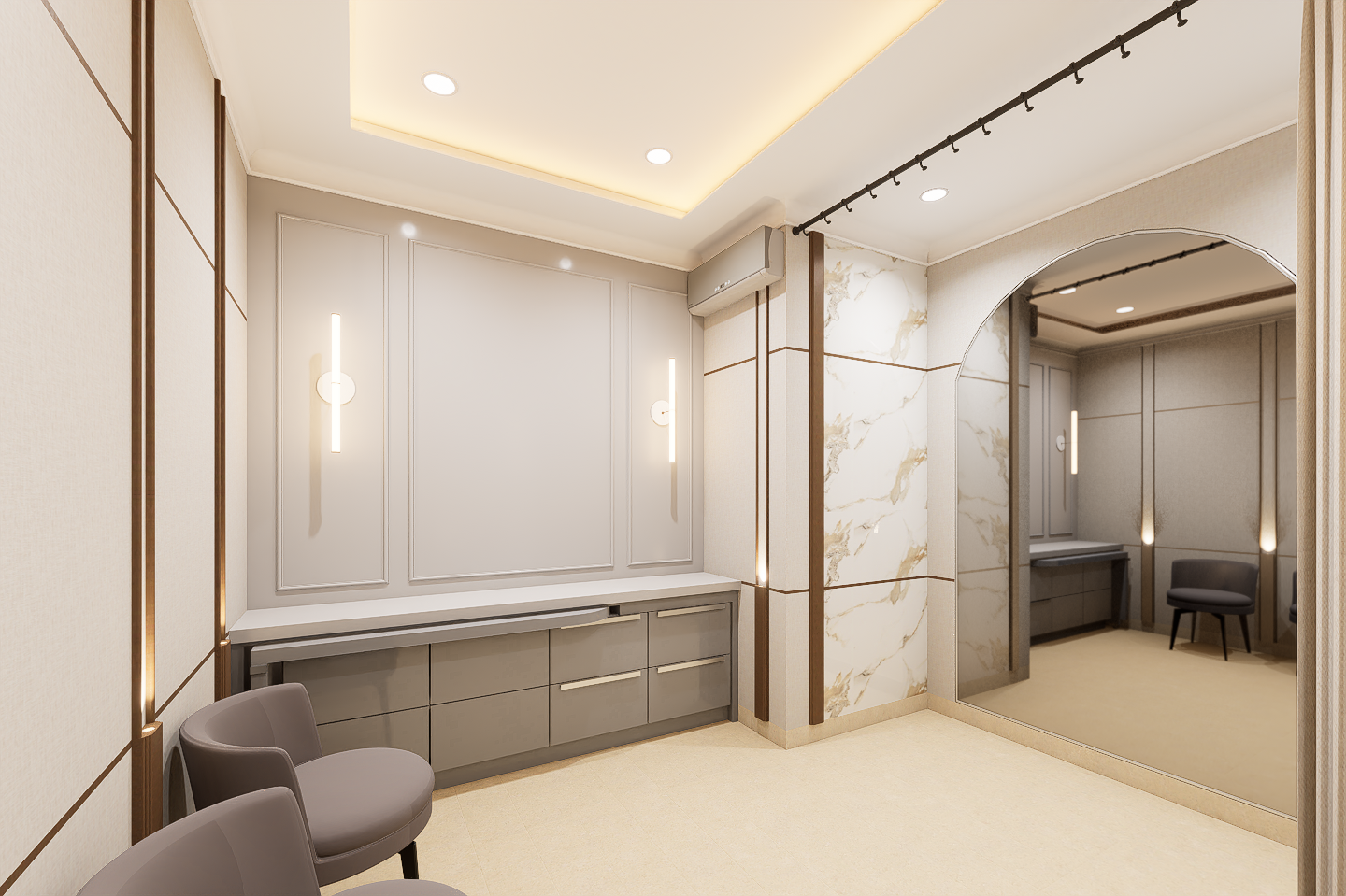 Modern interior room with beige walls, accent lighting, a large mirror, and two gray chairs.
