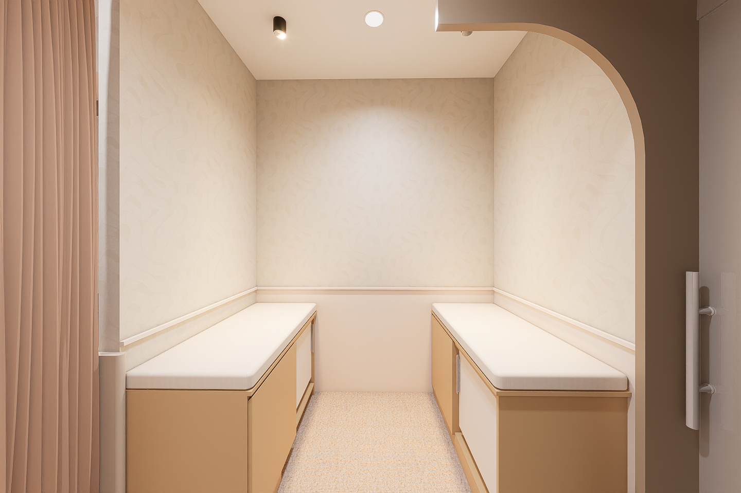 Small examination room with two cushioned examination tables on either side and a wall with beige wallpaper in the middle.