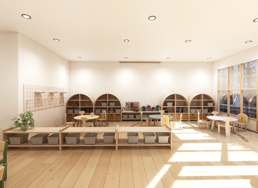Empty children's classroom with wooden furniture, shelves, tables, chairs, and a large window letting in sunlight.
