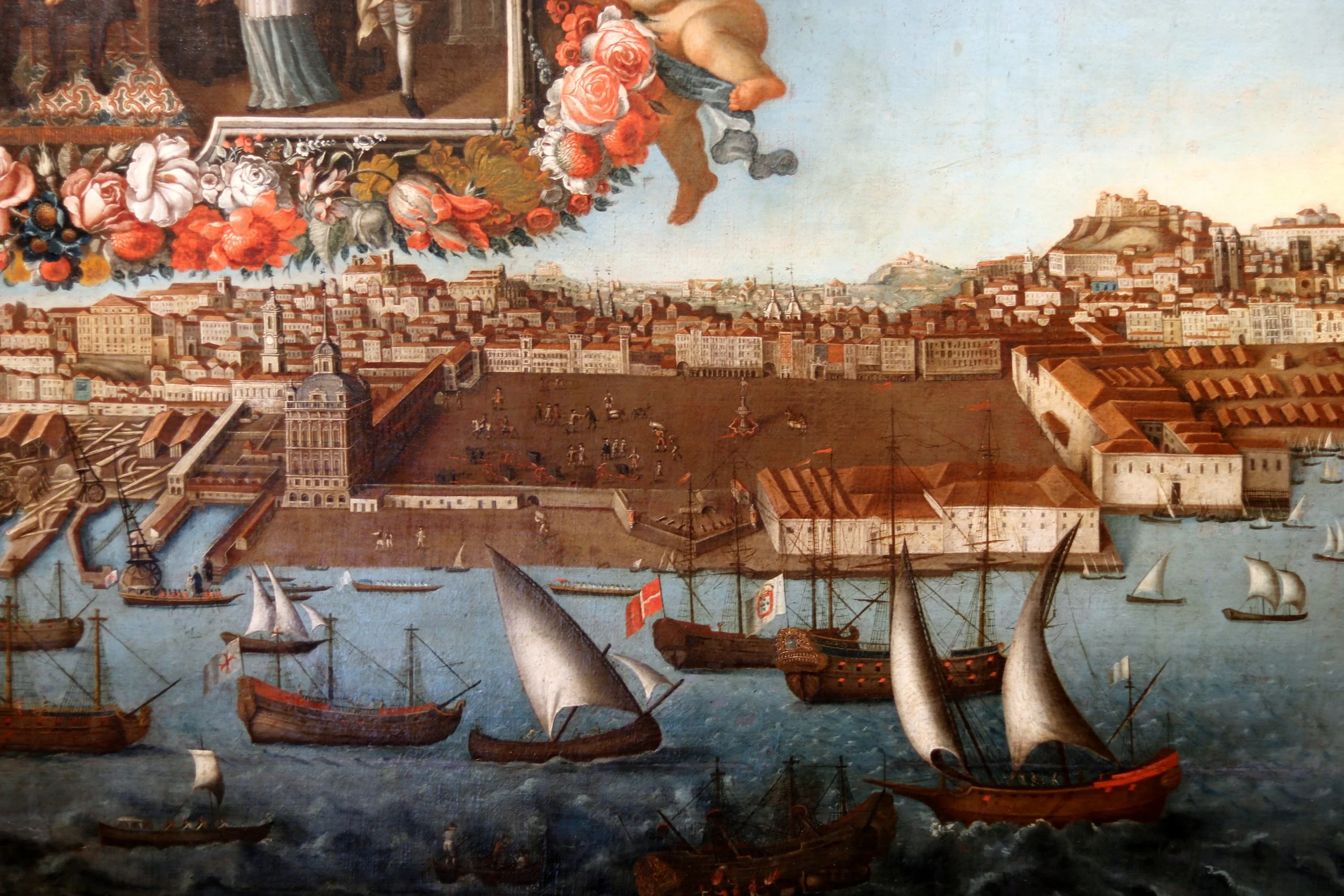 A historic maritime scene with sailing ships in a harbor, a cityscape with buildings and a large castle on a hill, and a decorative floral border in the upper part of the painting.