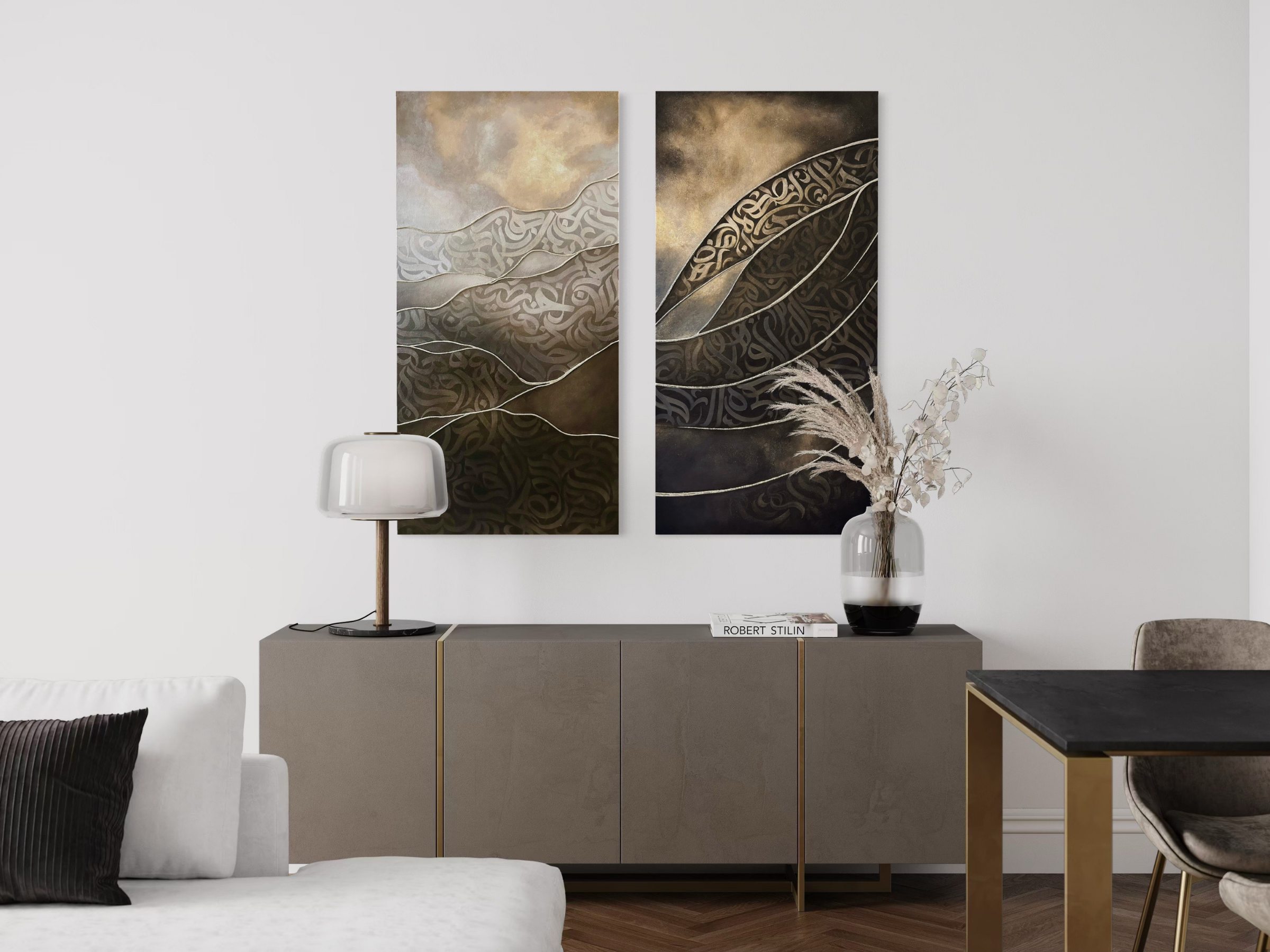 Two original mixed-media artworks by Shirin Roshanaie, featuring layered Persian and Arabic calligraphic forms in champagne, beige, bronze, and dark tones, displayed above a neutral wood console in a modern interior.  ShisArt Studio