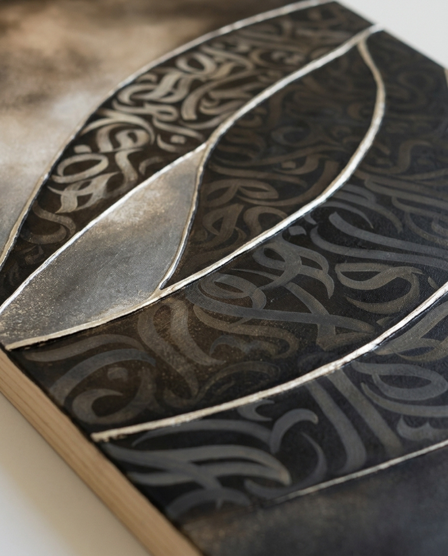 Close-up of “Rising Glyphs,” an original mixed-media artwork by Shirin Roshanaie, featuring layered Persian and Arabic calligraphic forms in charcoal, bronze, and warm gold tones. ShisArt Studio