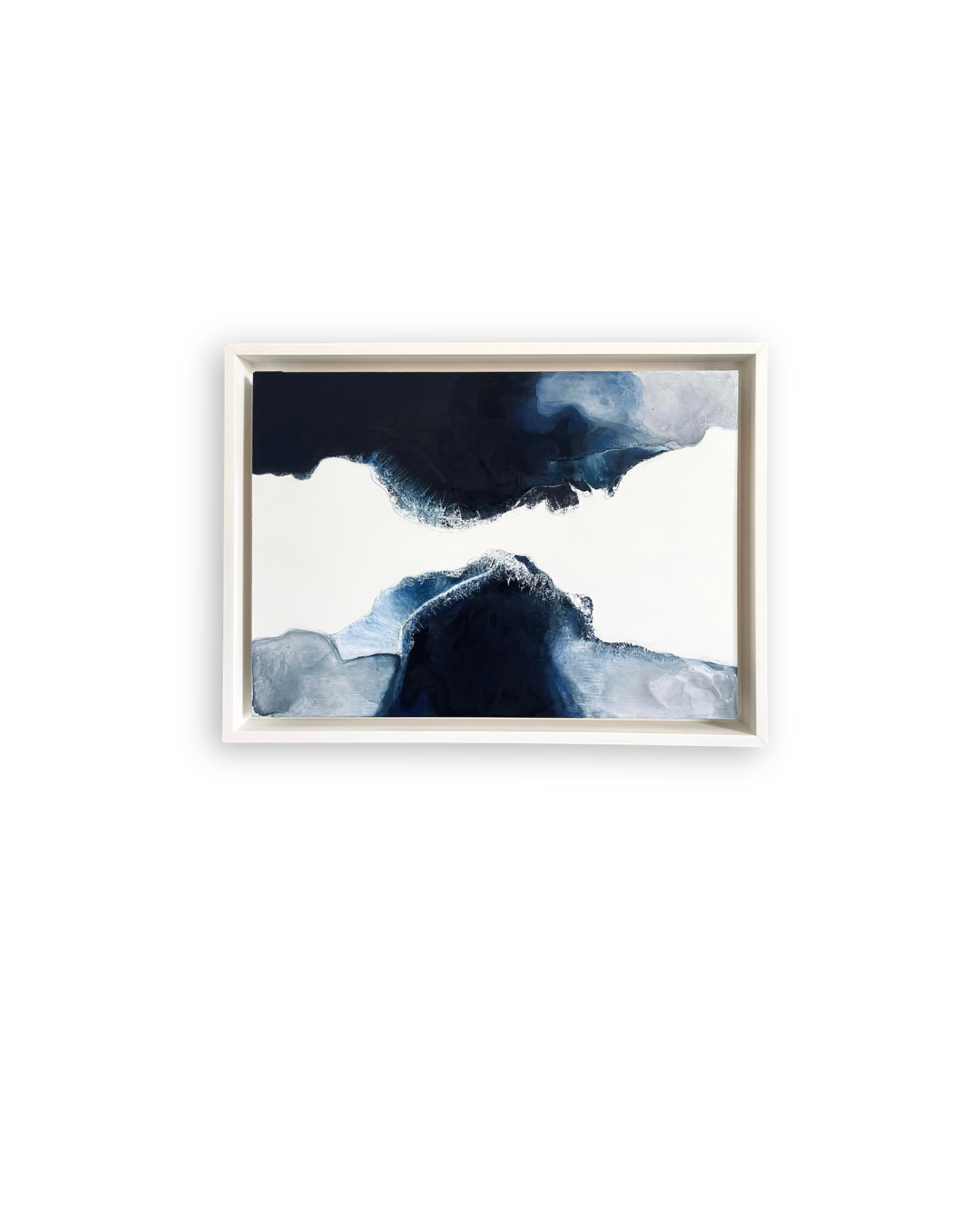 Abstract artwork from the “Déjà Vu” collection by Shirin Roshanaie, featuring layered navy blue, light blue, and white forms inspired by landscapes and water, in a white frame. ShisArt Studio
