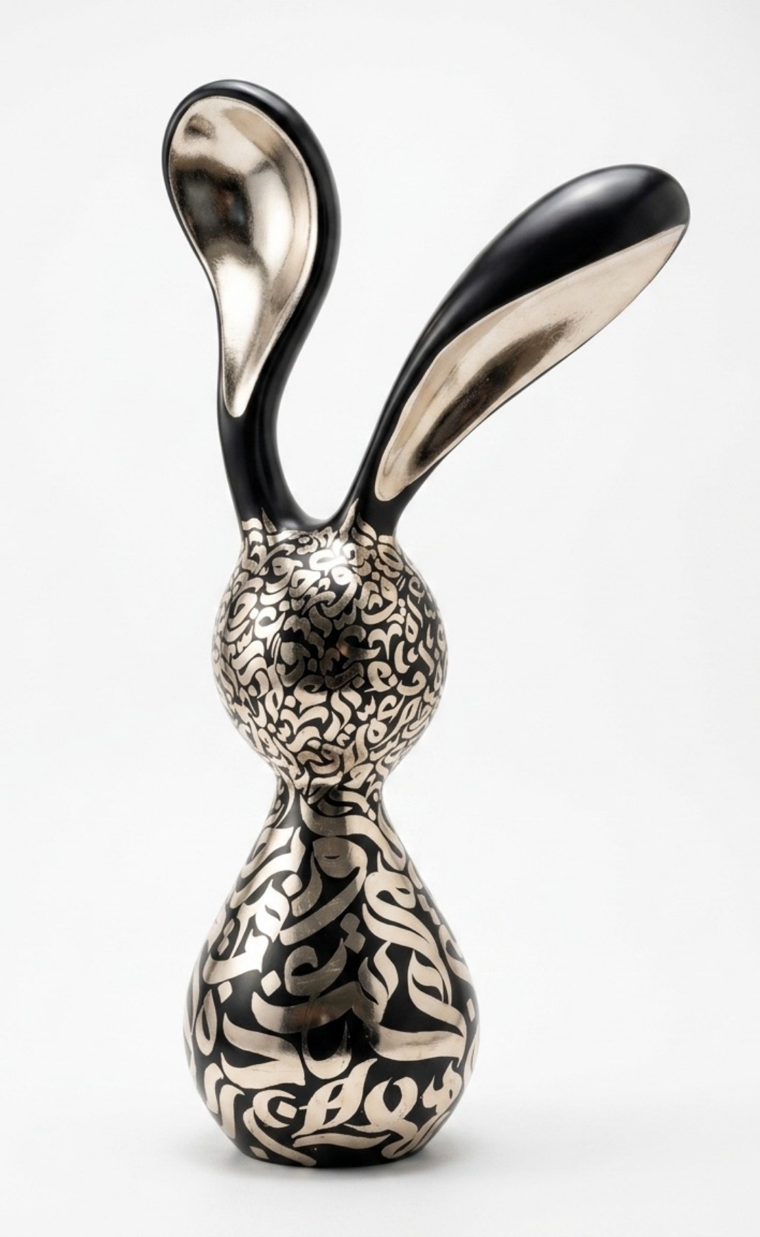 “Nouran,” an original mixed-media sculpture by Shirin Roshanaie, featuring a stylized rabbit form with Persian and Arabic calligraphic patterns in black and silver with metallic accents. ShisArt Studio