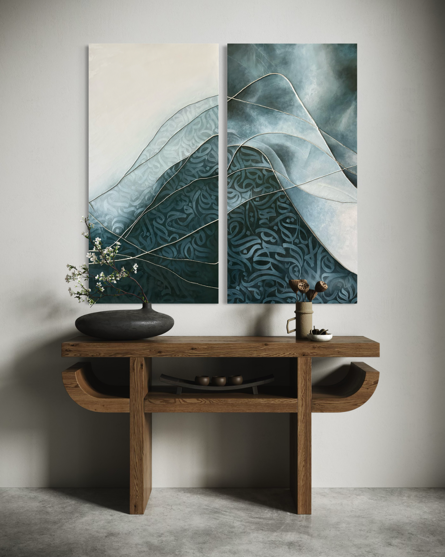 Two original mixed-media artworks by Shirin Roshanaie displayed above a wooden console table in a warm minimalist interior, featuring flowing blue-toned forms and Persian calligraphic patterns. ShisArt Studio