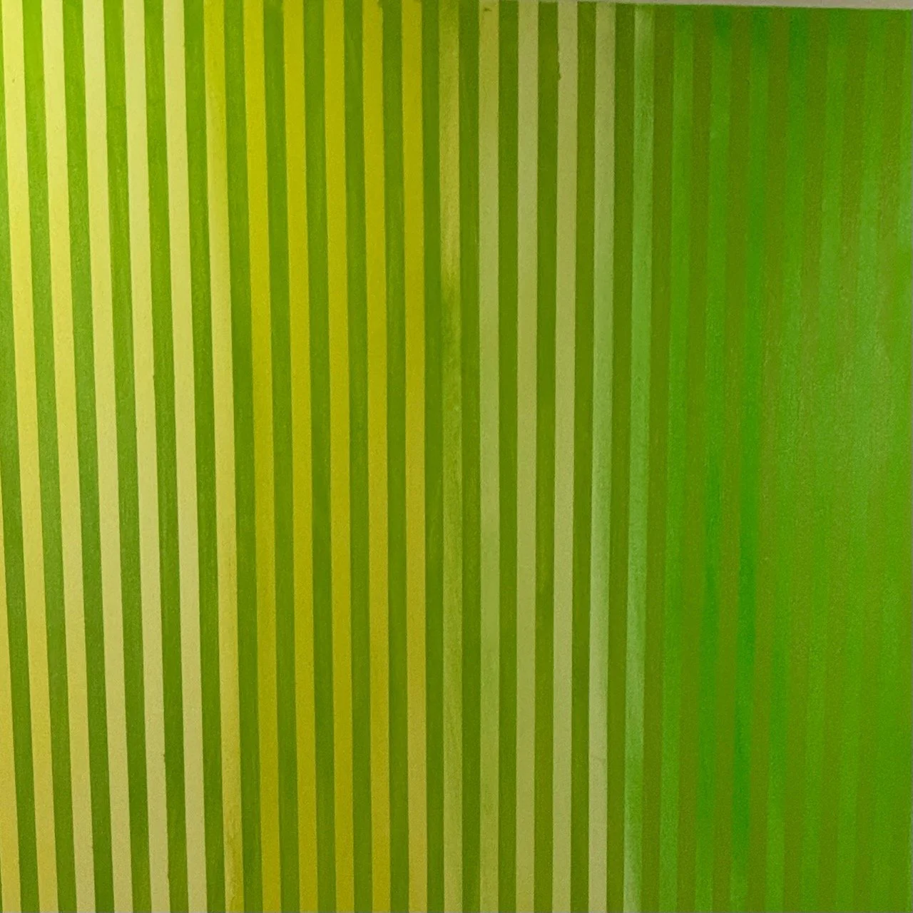 Close-up of a striped green and yellow pattern on a surface.