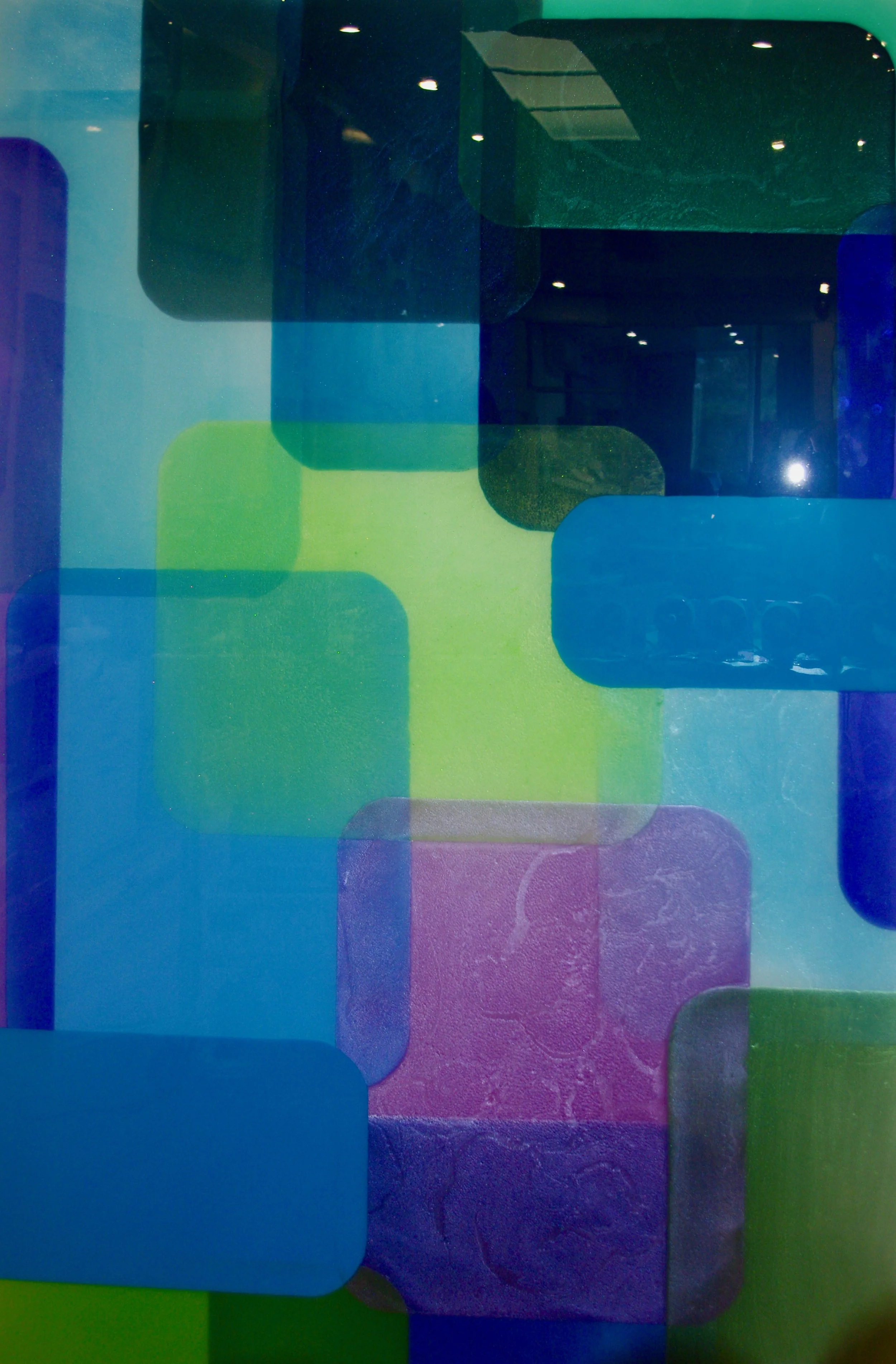 Abstract artwork featuring overlapping rounded rectangular shapes in shades of green, blue, purple, and black, with some areas of visible texture and speckled pattern.