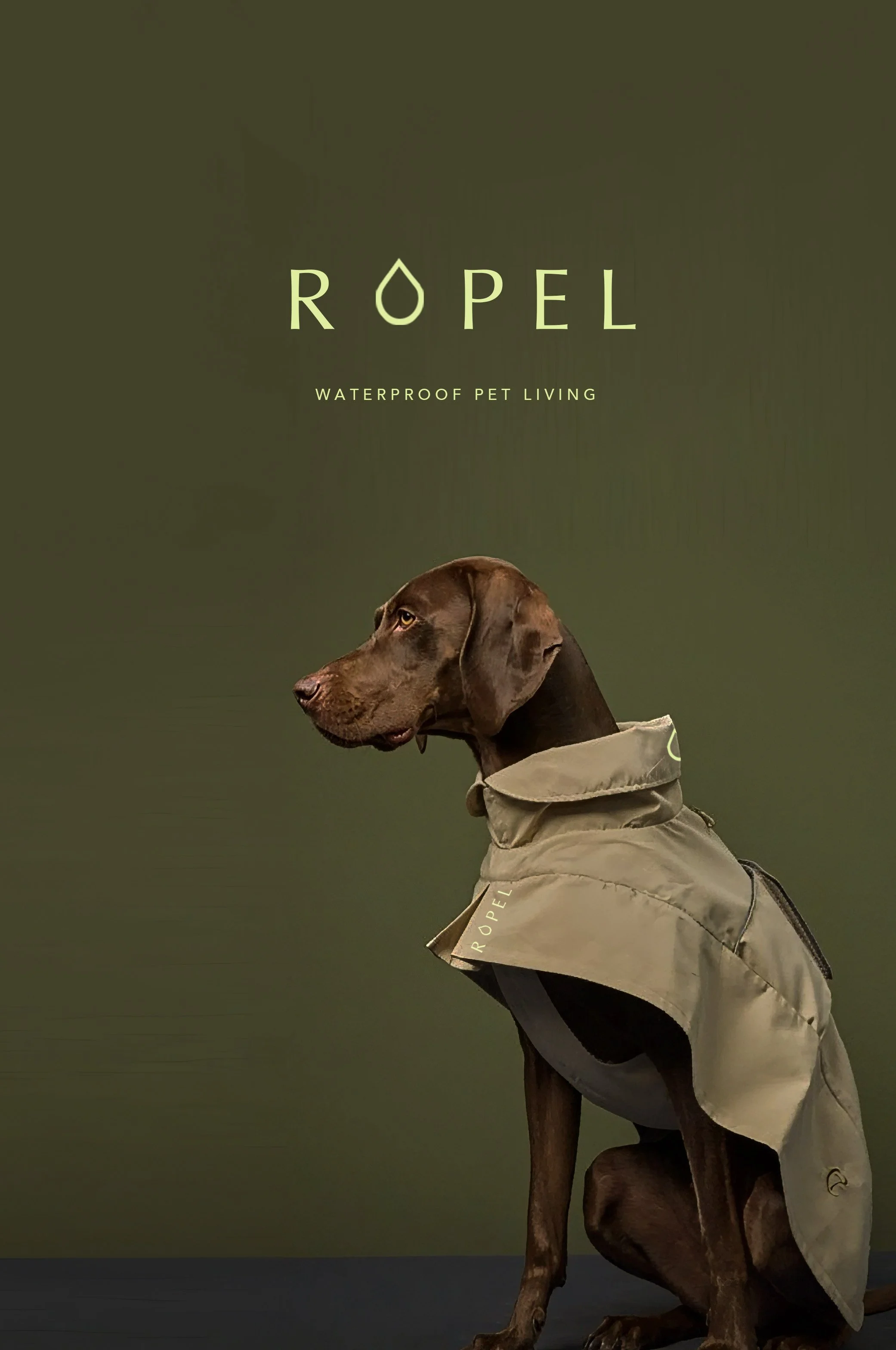 A brown dog wearing a waterproof jacket with the word "ROPEL" written on it, sitting against a dark green background.