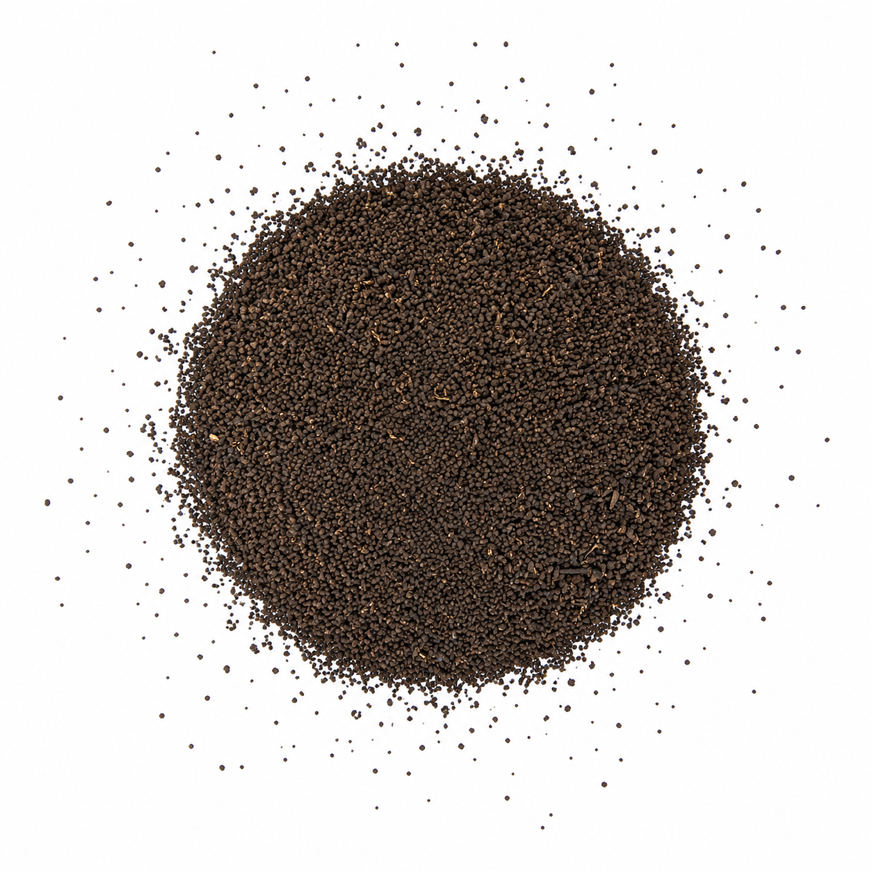 Closely packed black peppercorns forming a mound with some scattered around on a white background.