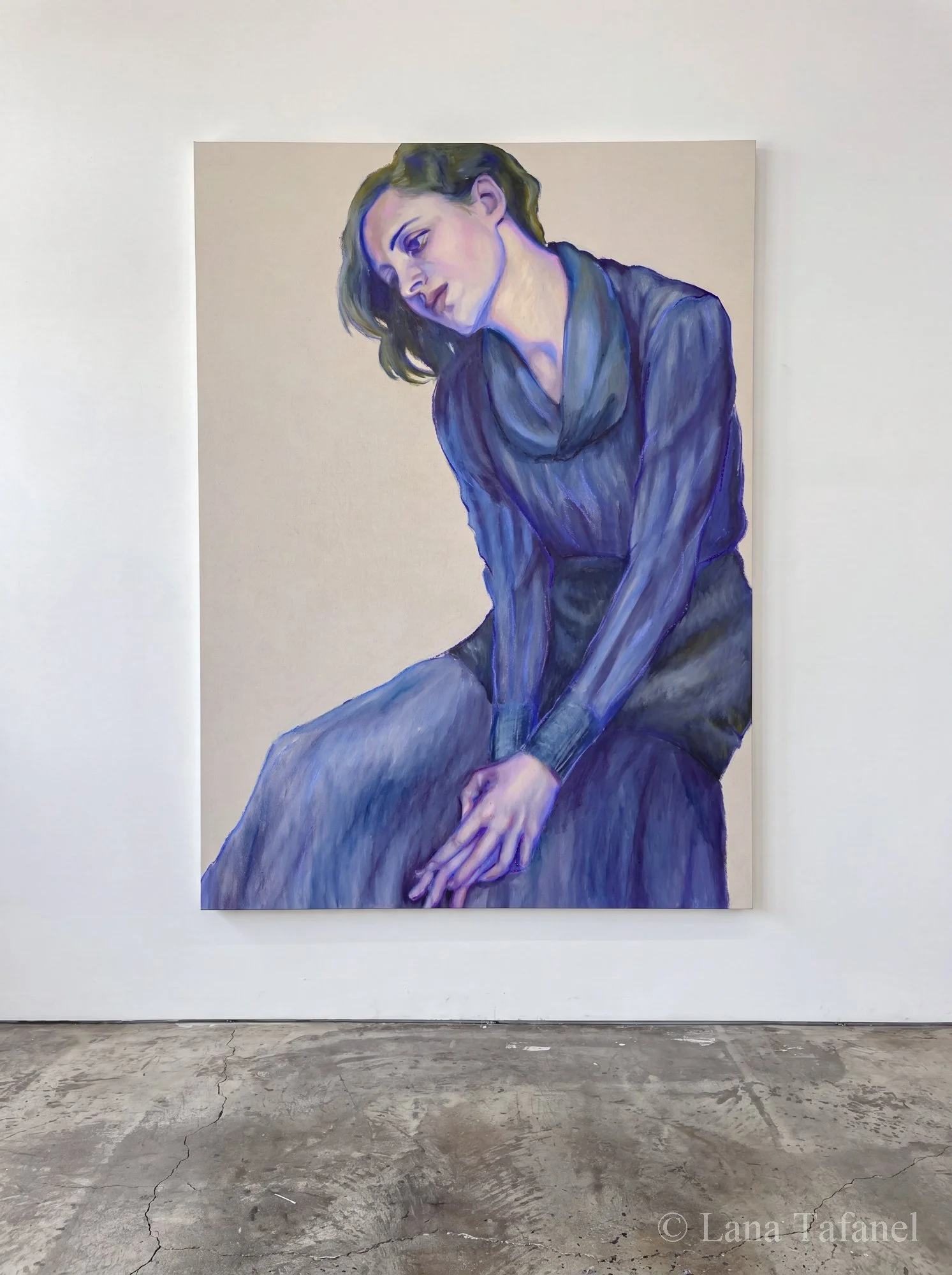Painting of a woman with short, wavy brown hair looking downwards. She is wearing a blue dress. Her arms are crossed in front. The background is plain linen, light-colored. painting is hanging on the gallery wall