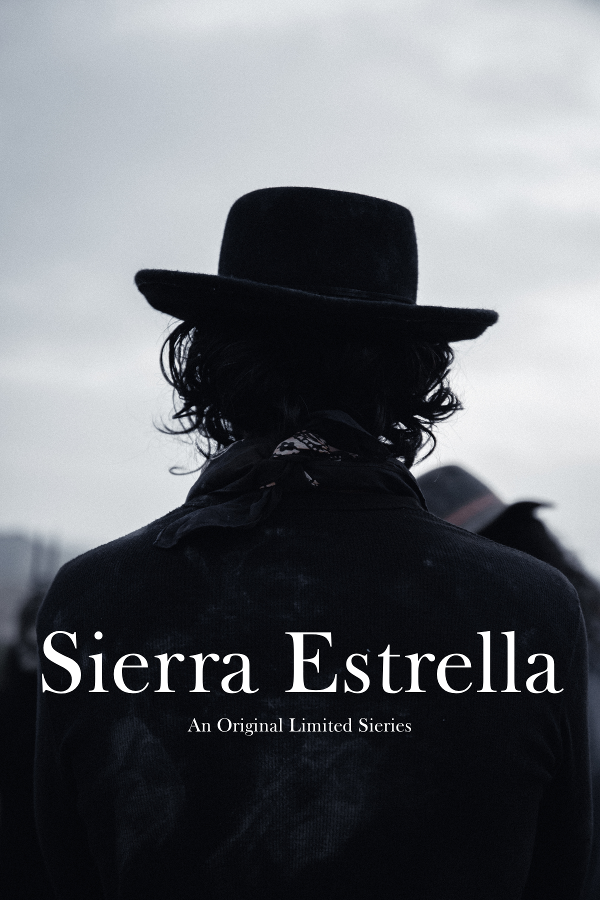 A person with curly hair wearing a wide-brimmed black hat and a dark jacket, seen from behind against a cloudy sky. Text over the image reads 'Sierra Estrella' and 'An Original Limited Series'.