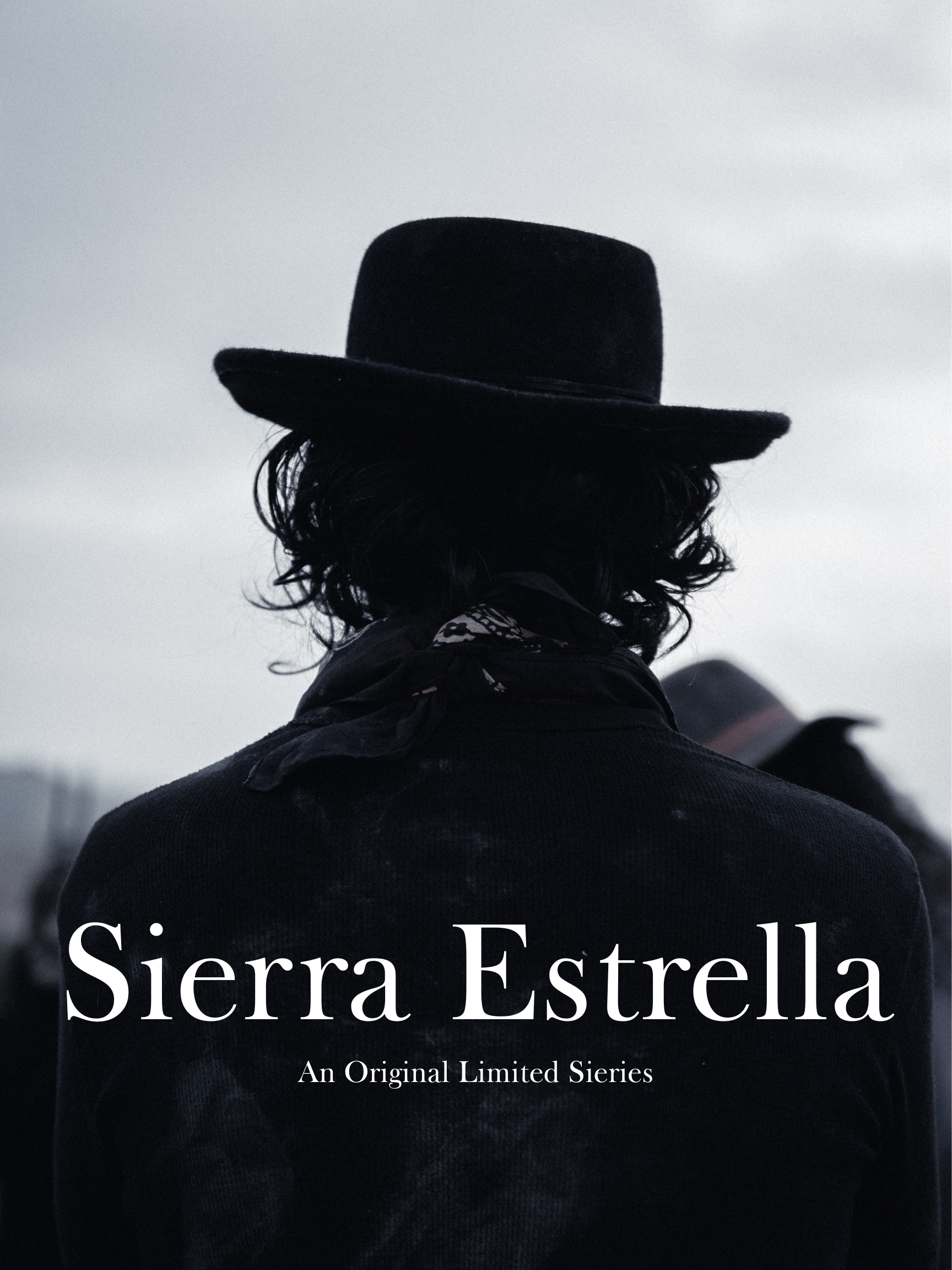 Person wearing a black hat and black clothing, picture taken from behind, with cloudy sky background, text overlay reading 'Sierra Estrella, An Original Limited Series'.