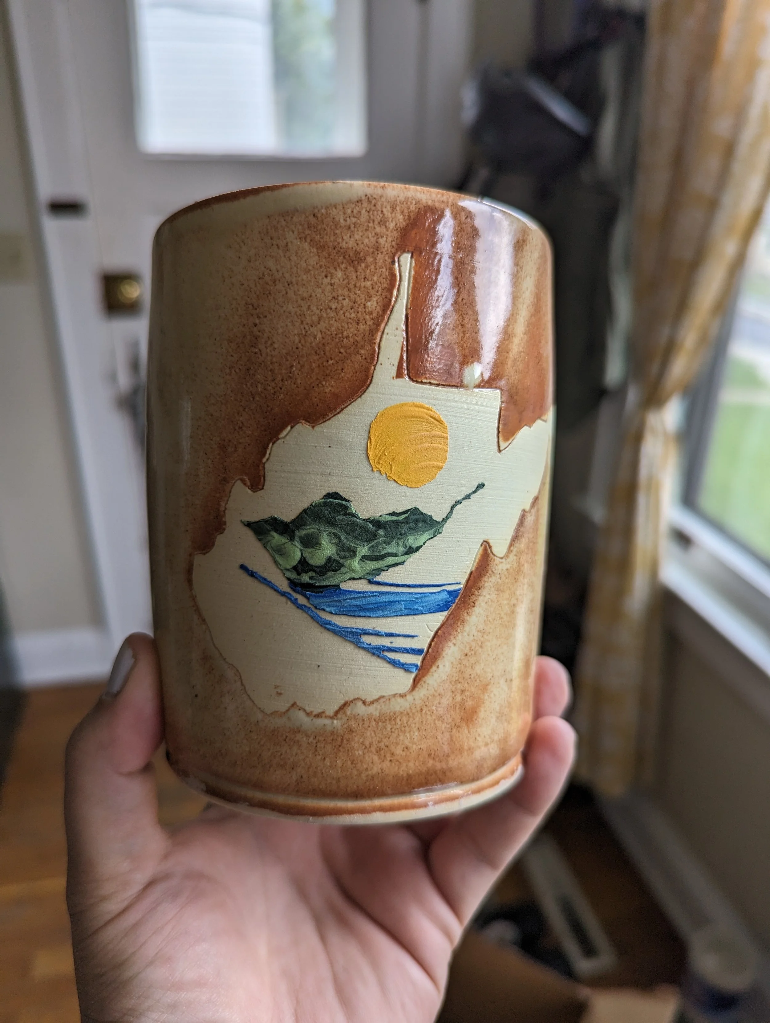 A large utensil holder with a custom state of WV scene.