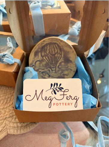 A small trinket dish with custom design presented at baby shower.