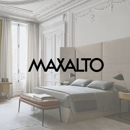 A luxurious bedroom with white walls, a large bed with gray bedding, a beige bench at the foot of the bed, and elegant curtains by tall windows, with the word 'MAXALTO' overlaid in bold black text.