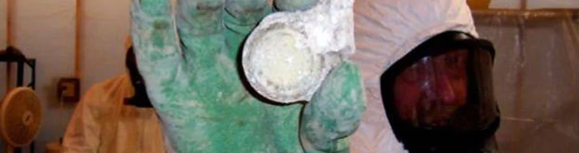 1130x300-rad-worker-holding-uranium.jpg
