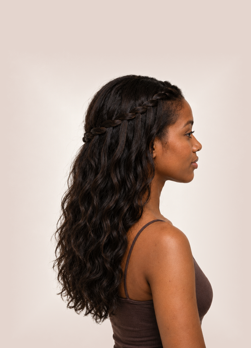 Side profile of woman with long dark hair and a waterfall braid.