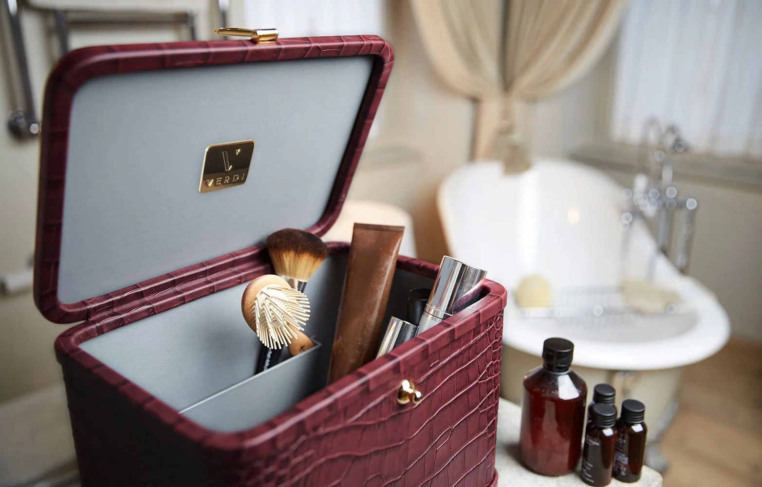 Atelier Verdi vanity case in wine coloured crocodile print leather created by Gabriella Verdi