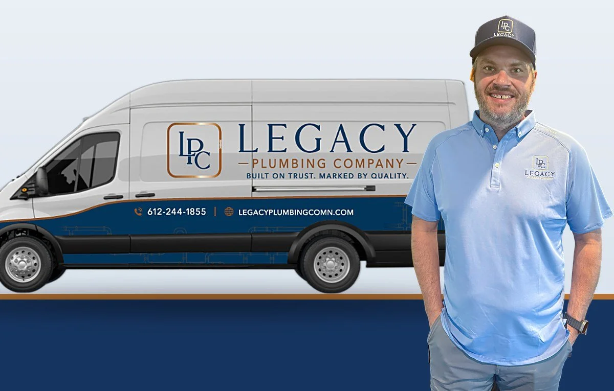 A man in a light blue polo shirt and a Legacy Plumbing Company cap standing in front of a company van with the Legacy Plumbing logo and contact information.