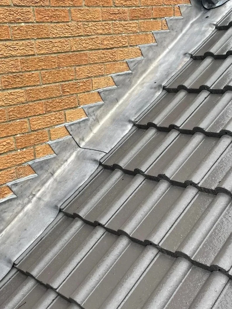 Roofing contractors on scaffolding during a re-roof in Gosforth