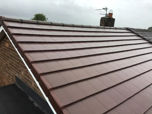 Roofer fitting a Velux window into a slate roof in Newcastle