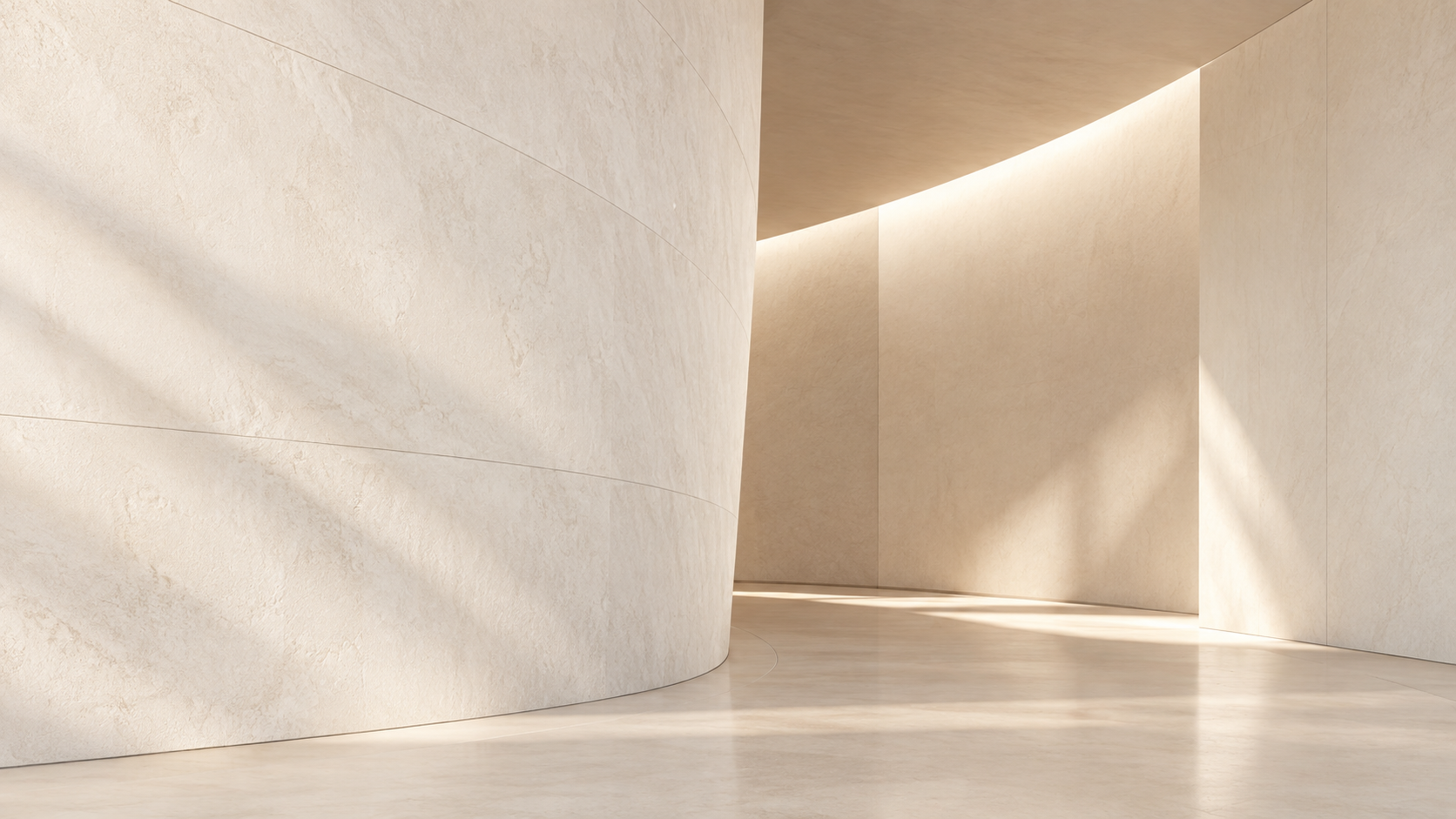 Minimalist beige interior with curved wall, smooth flooring, and soft lighting casting shadows.