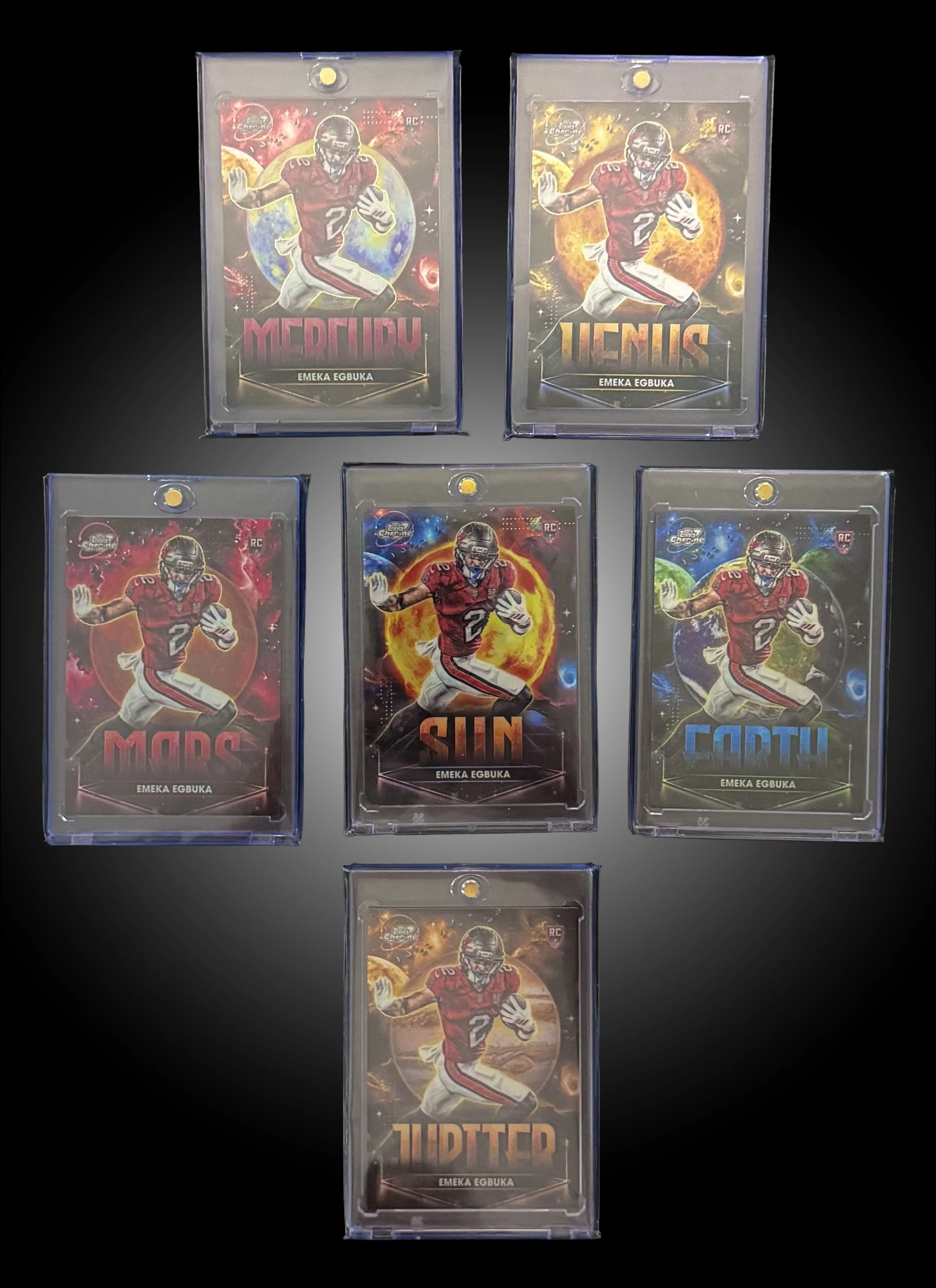 A collection of five trading cards featuring an American football player in a red uniform. The cards have different space-themed backgrounds with celestial objects and planetary imagery. Each card displays the player's name, Emeka Egbuka, and a different word: Mercury, Venus, Mars, Sun, and Jupiter.