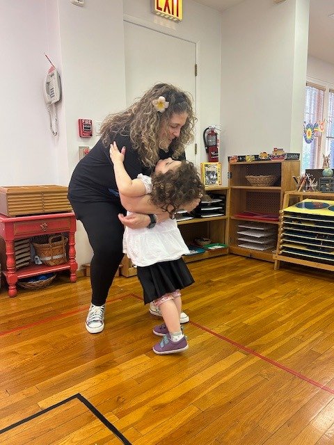 Claudia Colonna, author of children's book "Bajette's Ballon" pictured with child during her Magic of Smiles book tour.