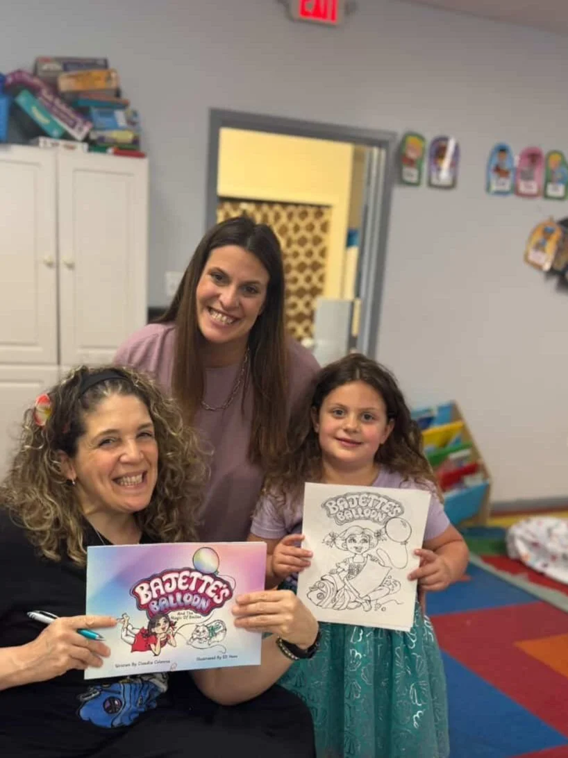 Claudia Colonna, author of children's book "Bajette's Ballon" pictured with a child during her Magic of Smiles book tour.
