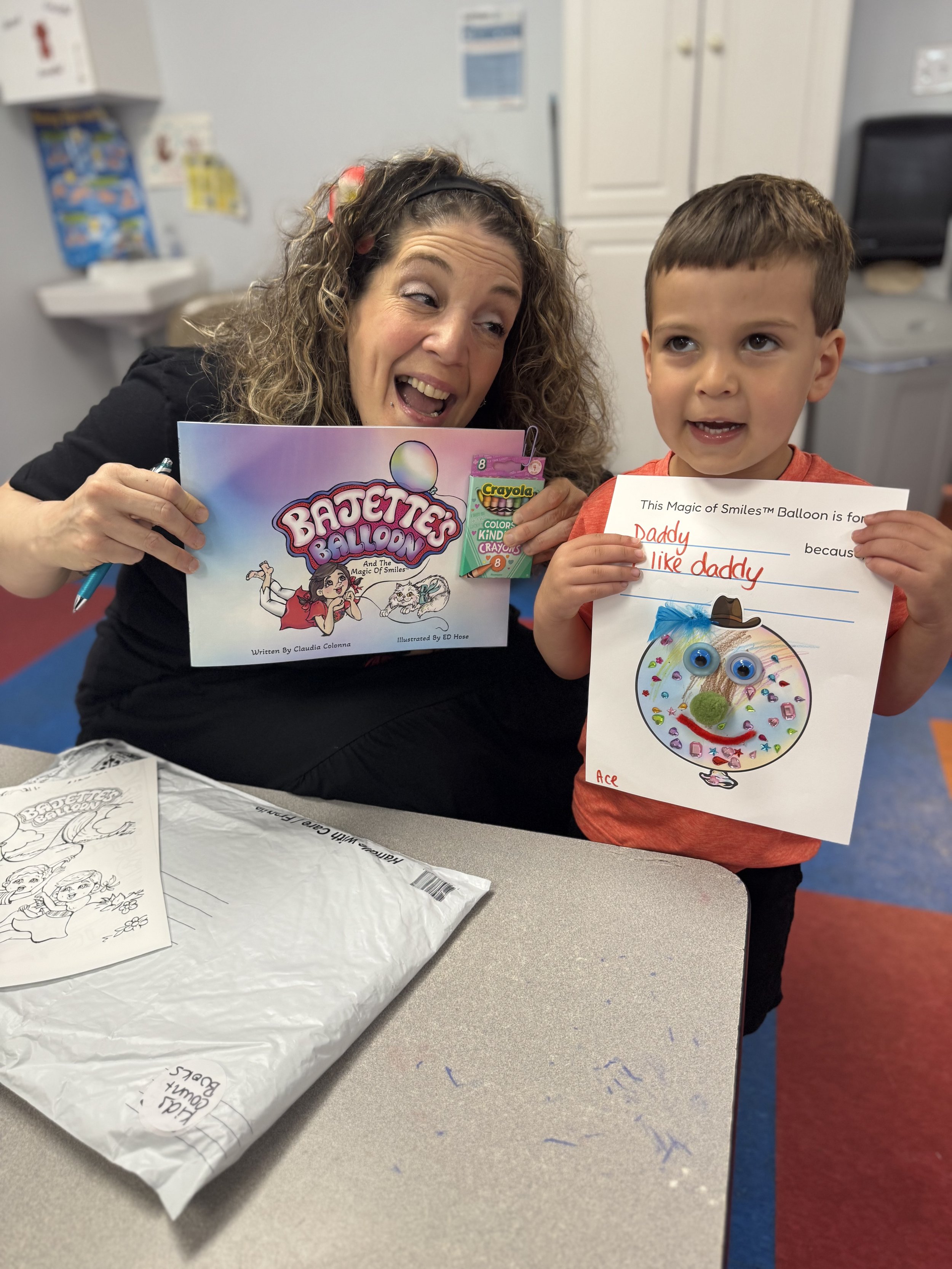 Claudia Colonna, author of children's book "Bajette's Ballon" pictured with child during her Magic of Smiles book tour.
