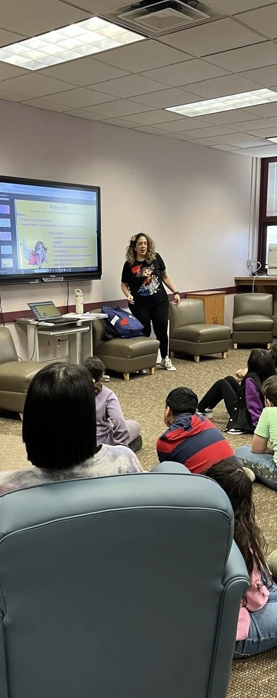 Claudia Colonna, author of children's book "Bajette's Balloon" pictured with children during her Magic of Smiles book tour. Claudia toured to various schools to read aloud to children.