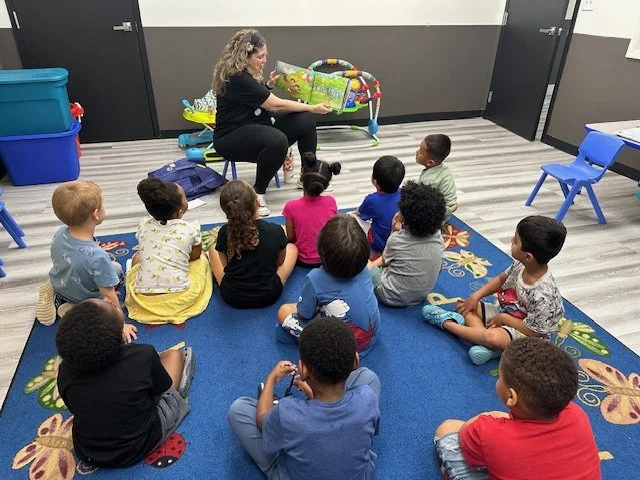 Claudia Colonna, author of children's book "Bajette's Balloon" pictured with children during her Magic of Smiles book tour. Claudia toured to various schools to read aloud to children.