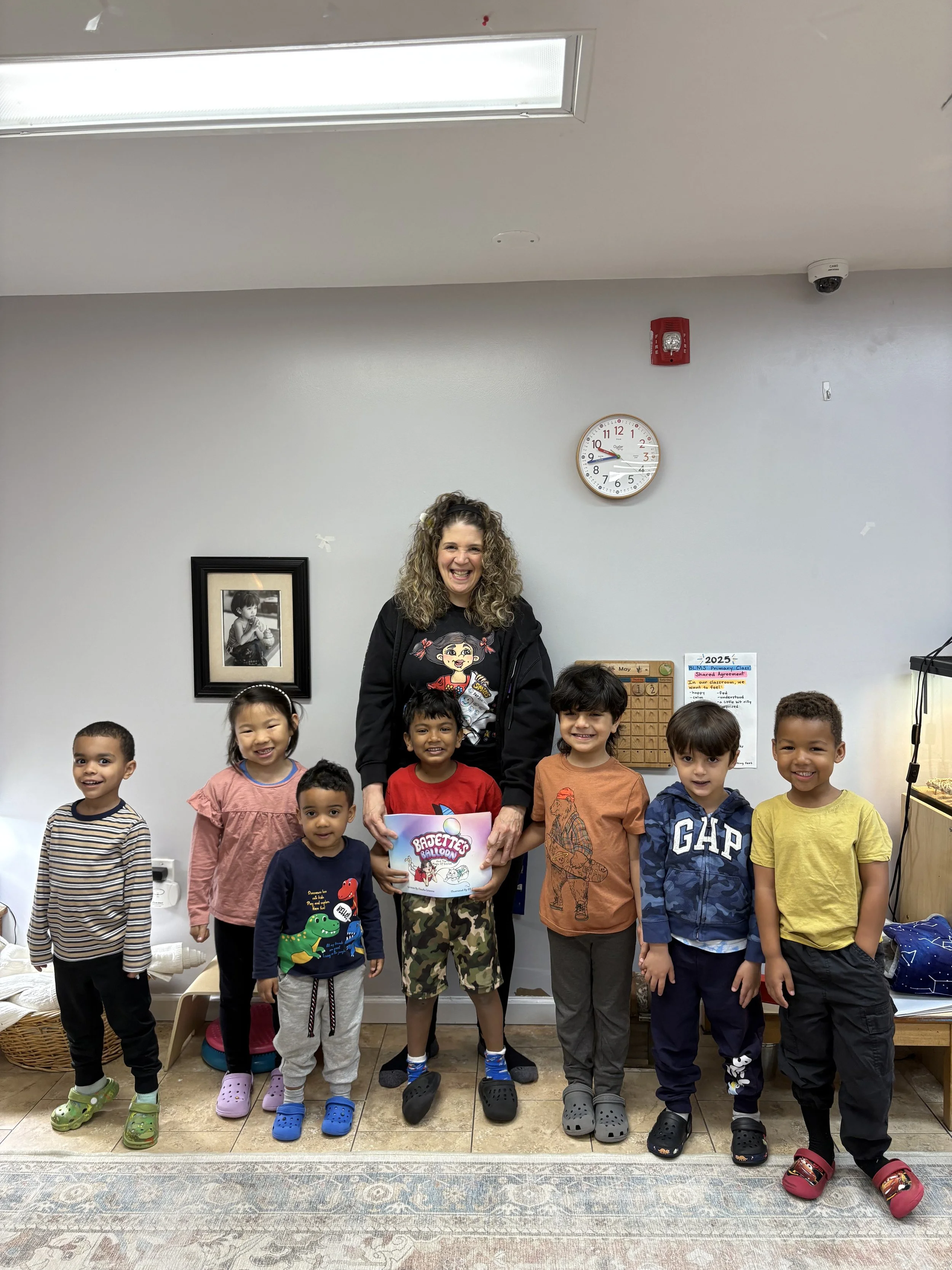 Claudia Colonna, author of children's book "Bajette's Ballon" pictured with children during her Magic of Smiles book tour.