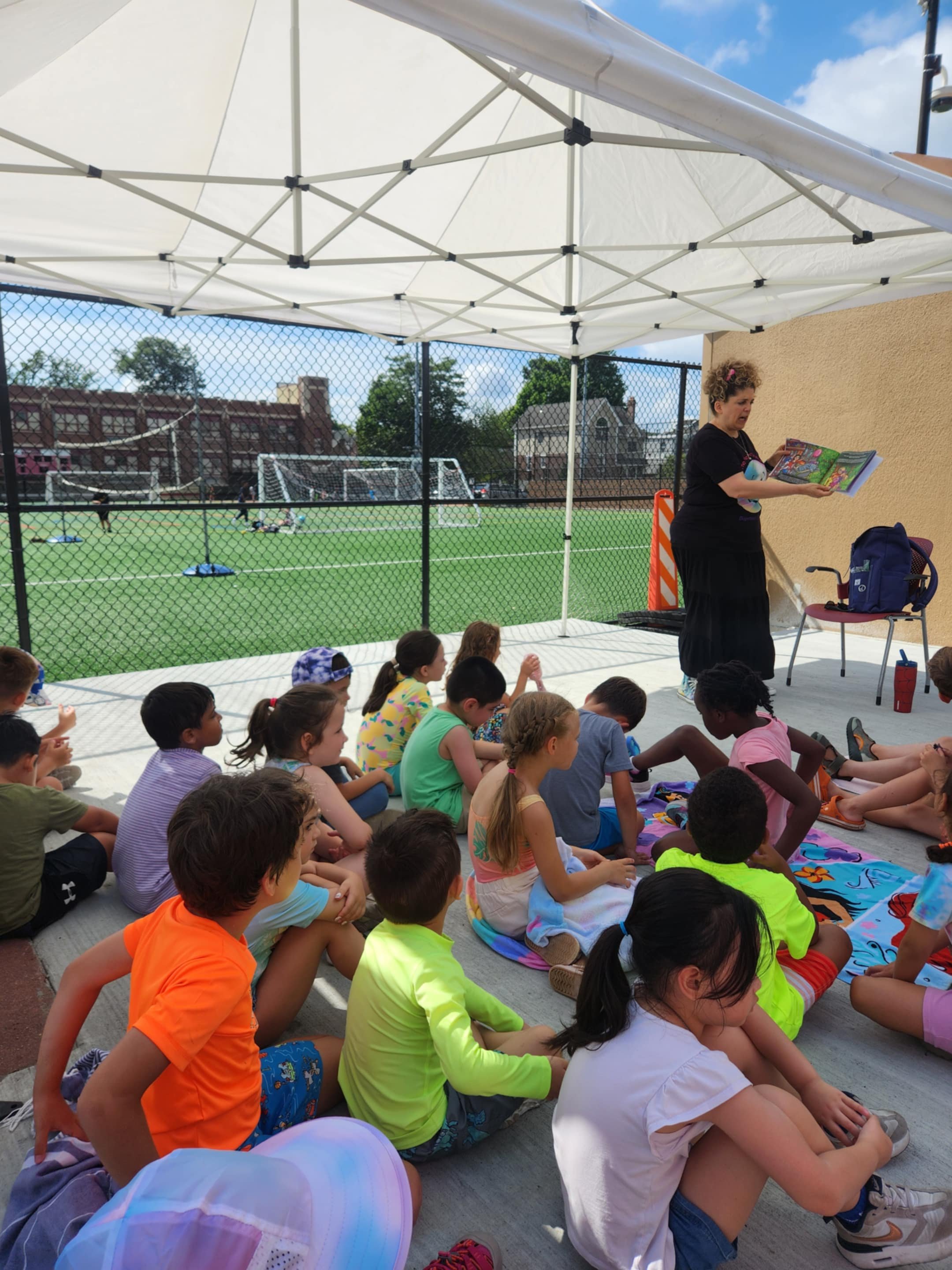 Claudia Colonna, author of children's book "Bajette's Balloon" pictured with children during her Magic of Smiles book tour. Claudia toured to various schools to read aloud to children.