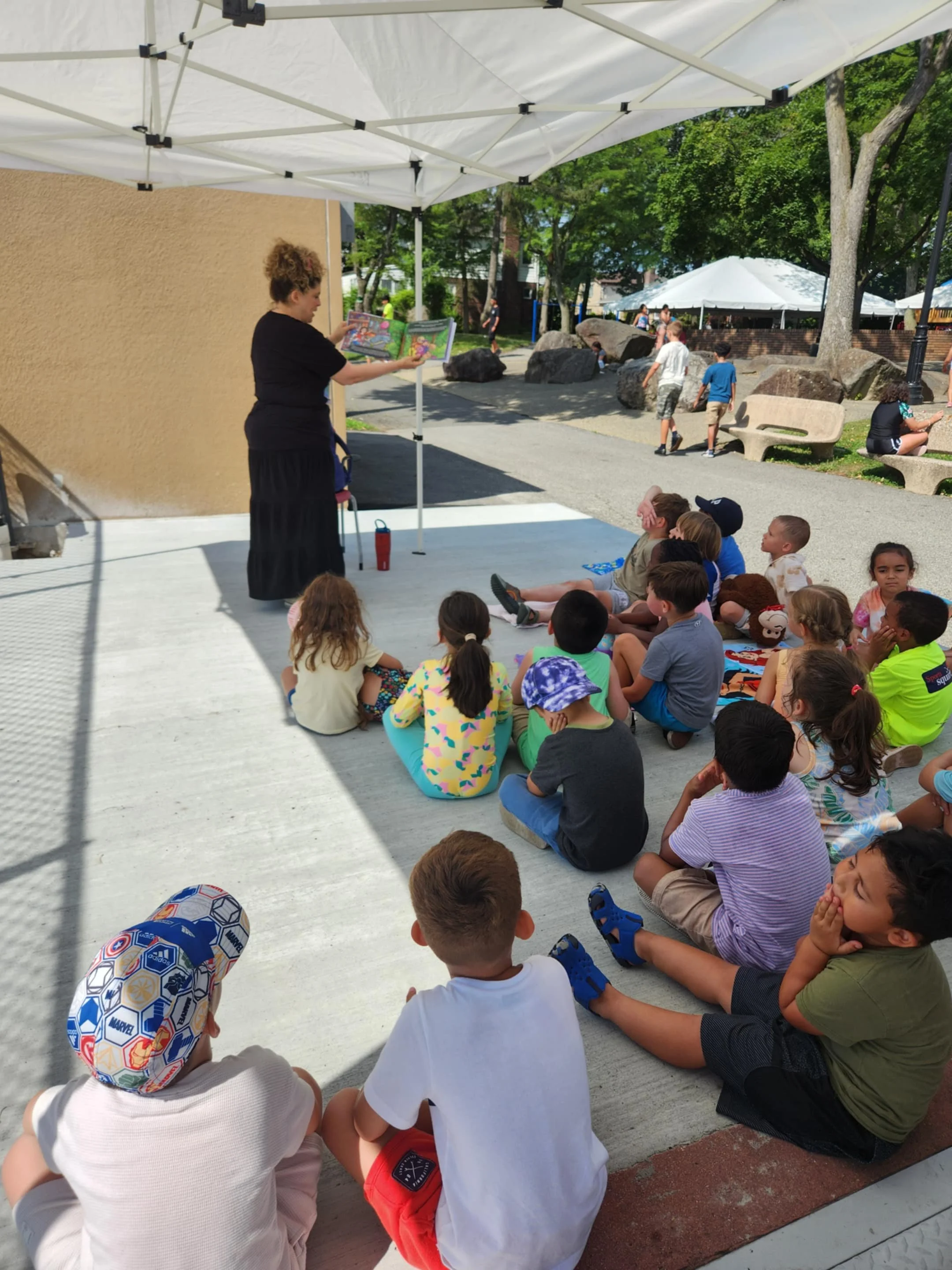 Claudia Colonna, author of children's book "Bajette's Balloon" pictured with children during her Magic of Smiles book tour. Claudia toured to various schools to read aloud to children.