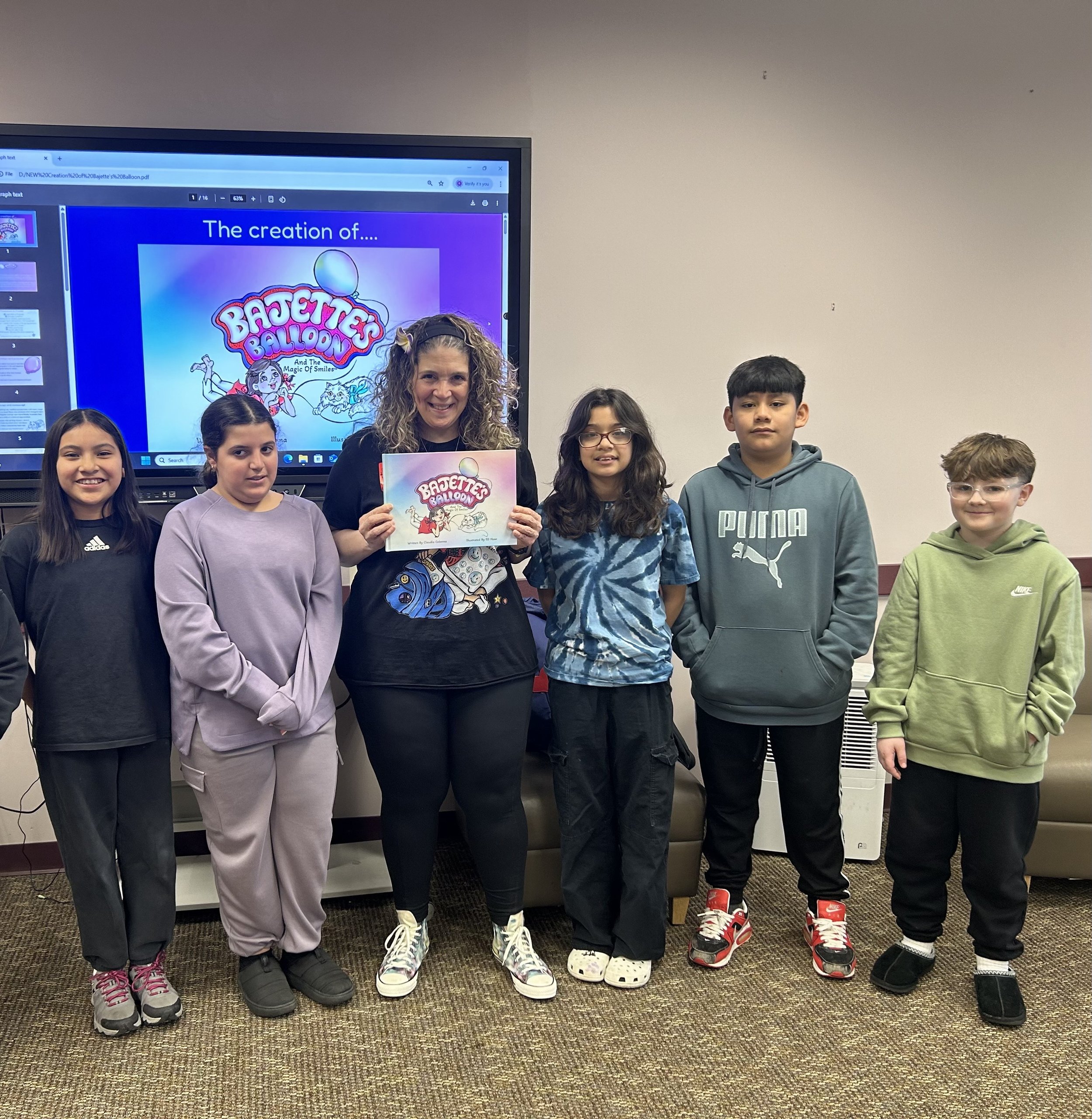 Claudia Colonna, author of children's book "Bajette's Balloon" pictured with children during her Magic of Smiles book tour. Claudia toured to various schools to read aloud to children.