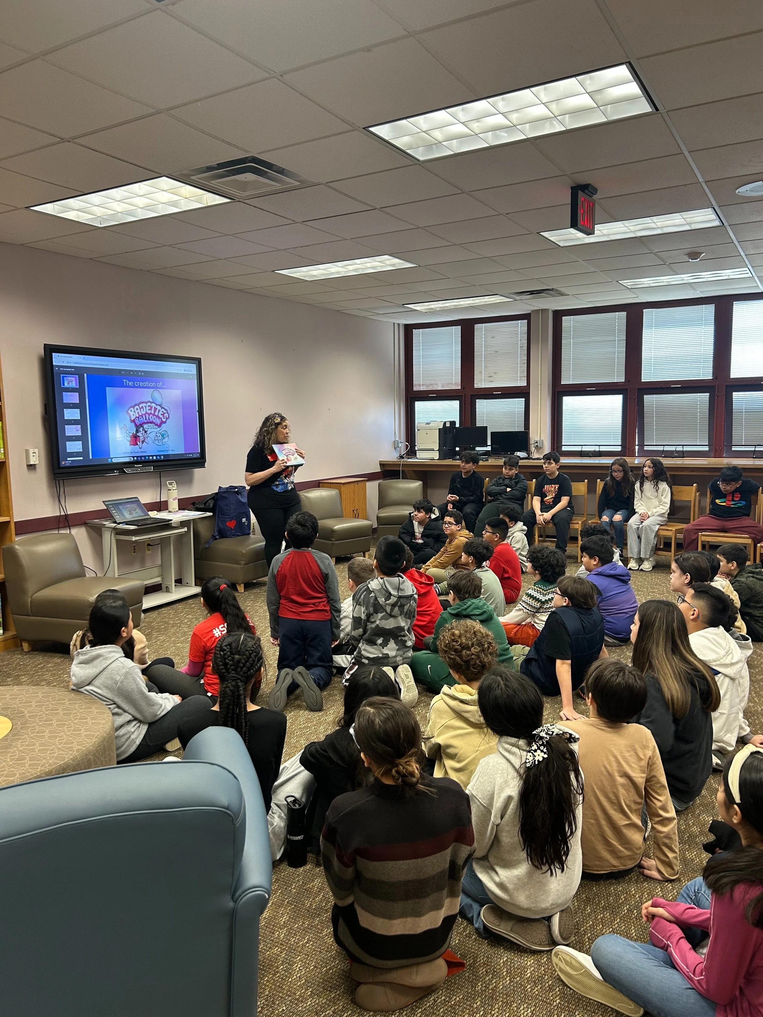 Claudia Colonna, author of children's book "Bajette's Balloon" pictured with children during her Magic of Smiles book tour. Claudia toured to various schools to read aloud to children.
