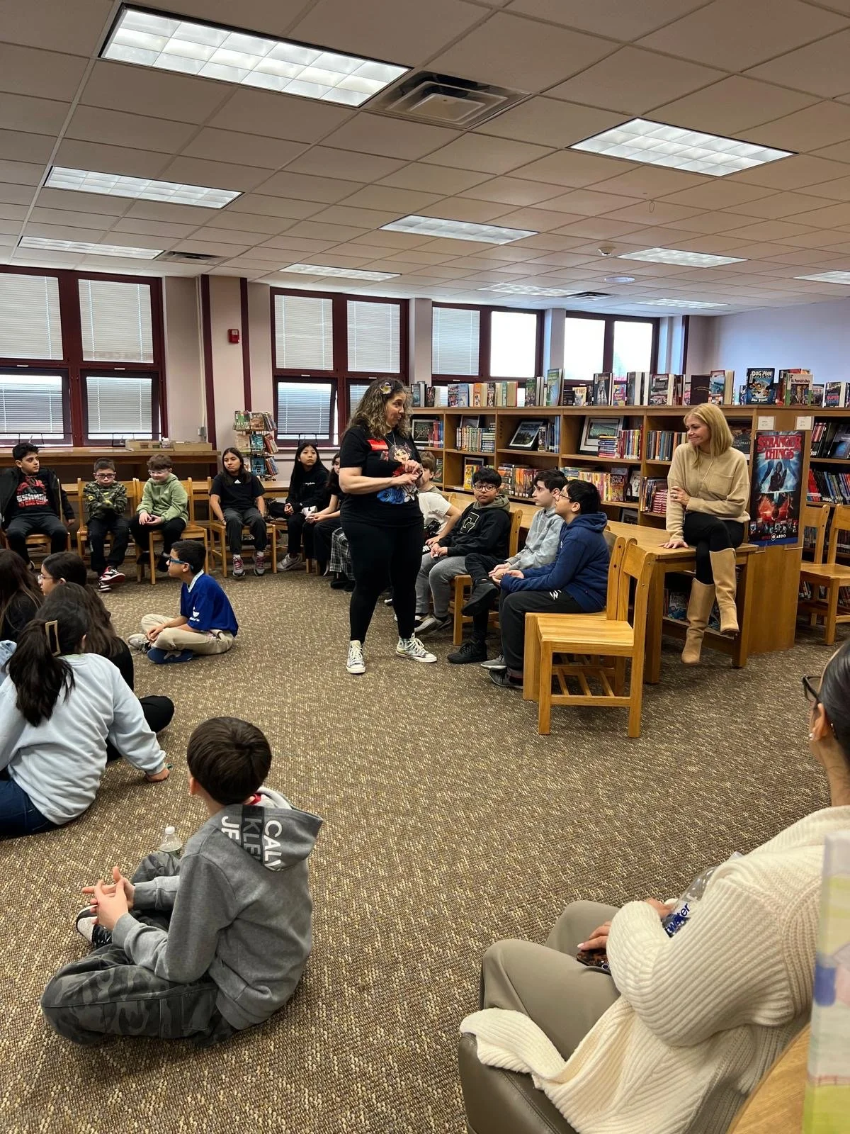 Claudia Colonna, author of children's book "Bajette's Balloon" pictured with children during her Magic of Smiles book tour. Claudia toured to various schools to read aloud to children.