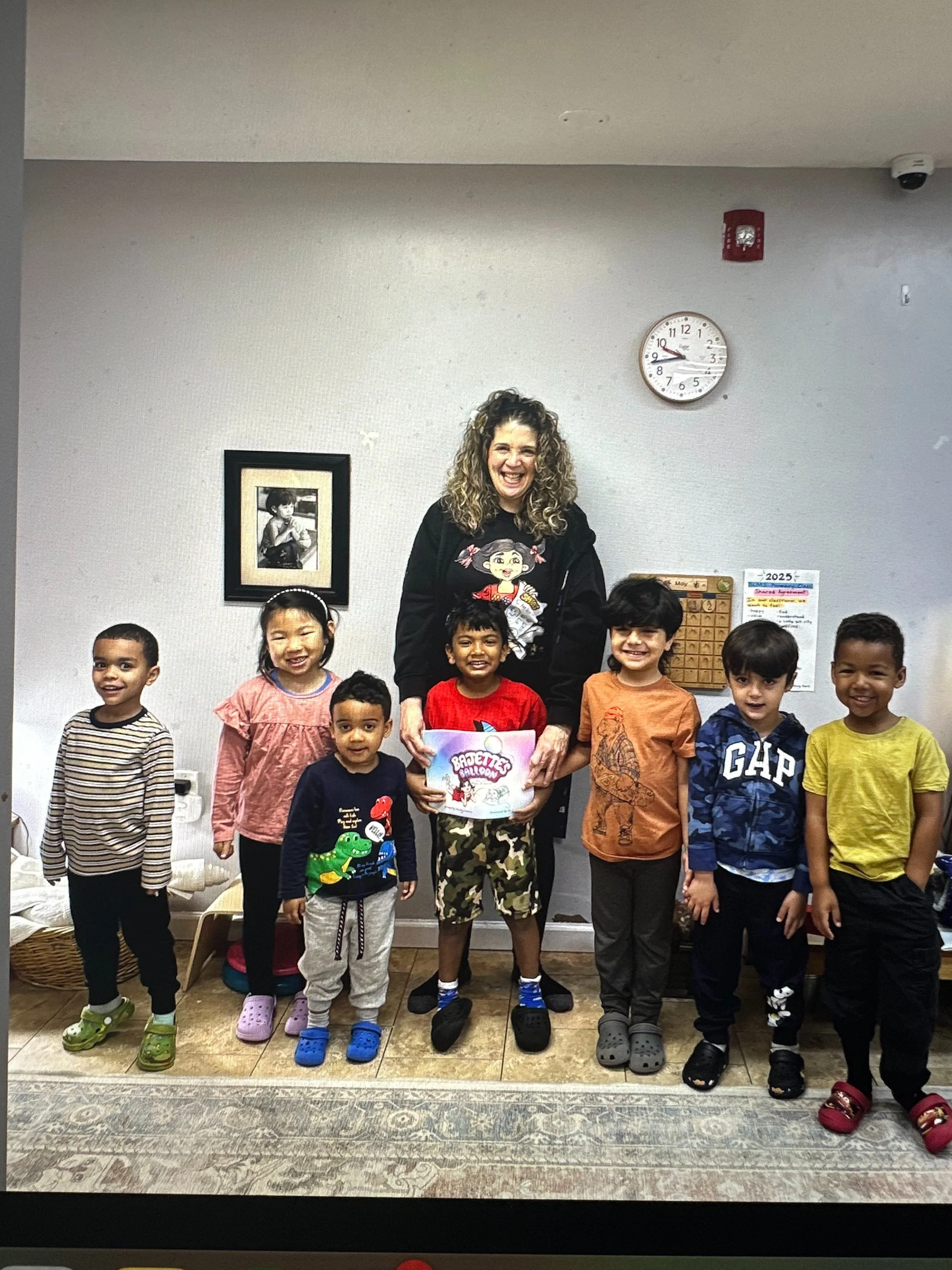 Claudia Colonna, author of children's book "Bajette's Balloon" pictured with children during her Magic of Smiles book tour. Claudia toured to various schools to read aloud to children.
