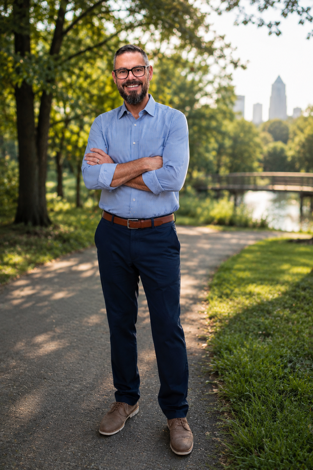Travis M. Hurst standing on a tree-lined path in a Central Indiana park.