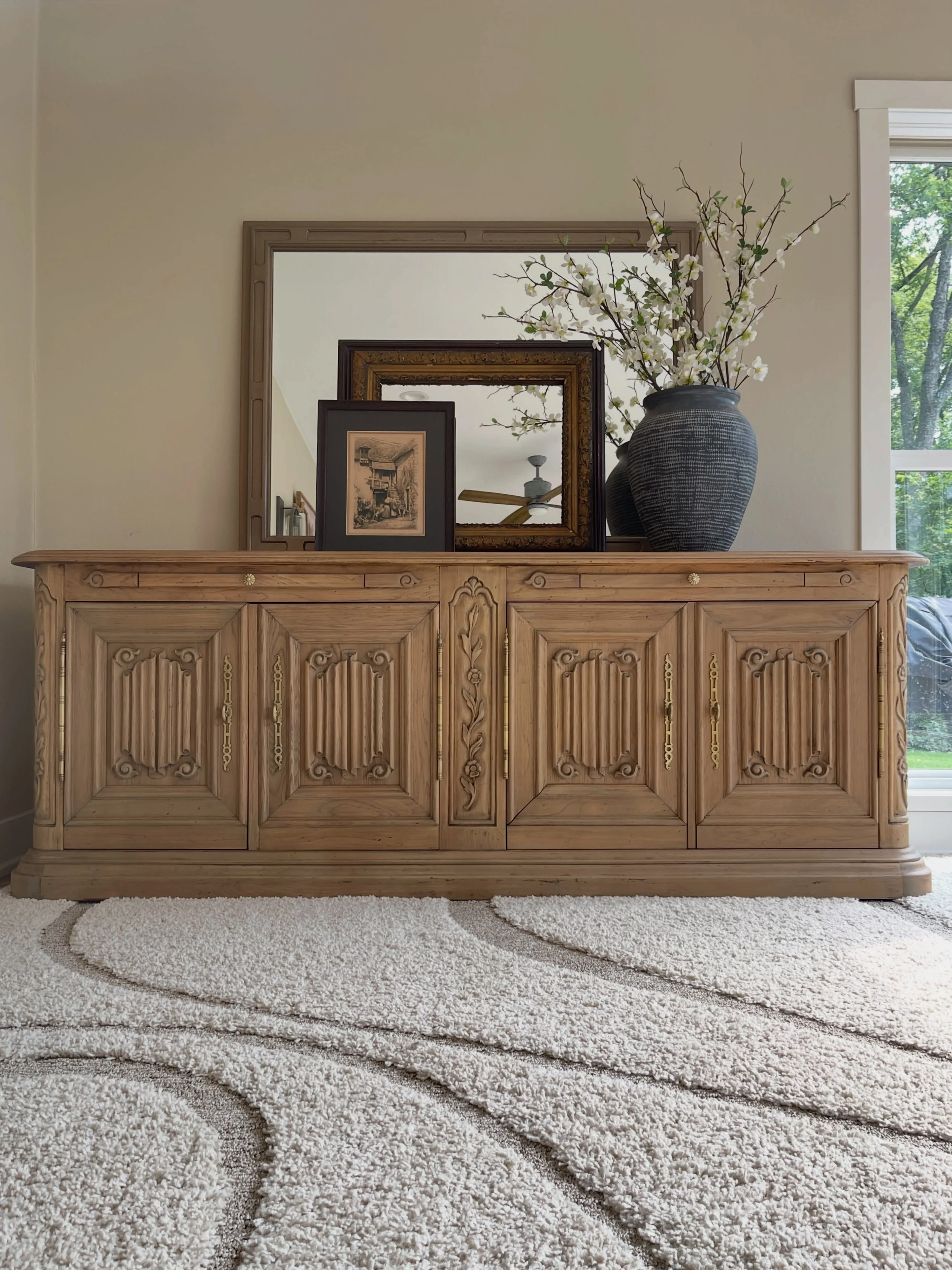 *update: now SOLD - this one didn&rsquo;t last long!* This vintage carved wood sideboard is a showstopper, with all the character and charm of a European, old-world piece. Beautifully carved details, paneled doors, delicate floral carving, and a warm