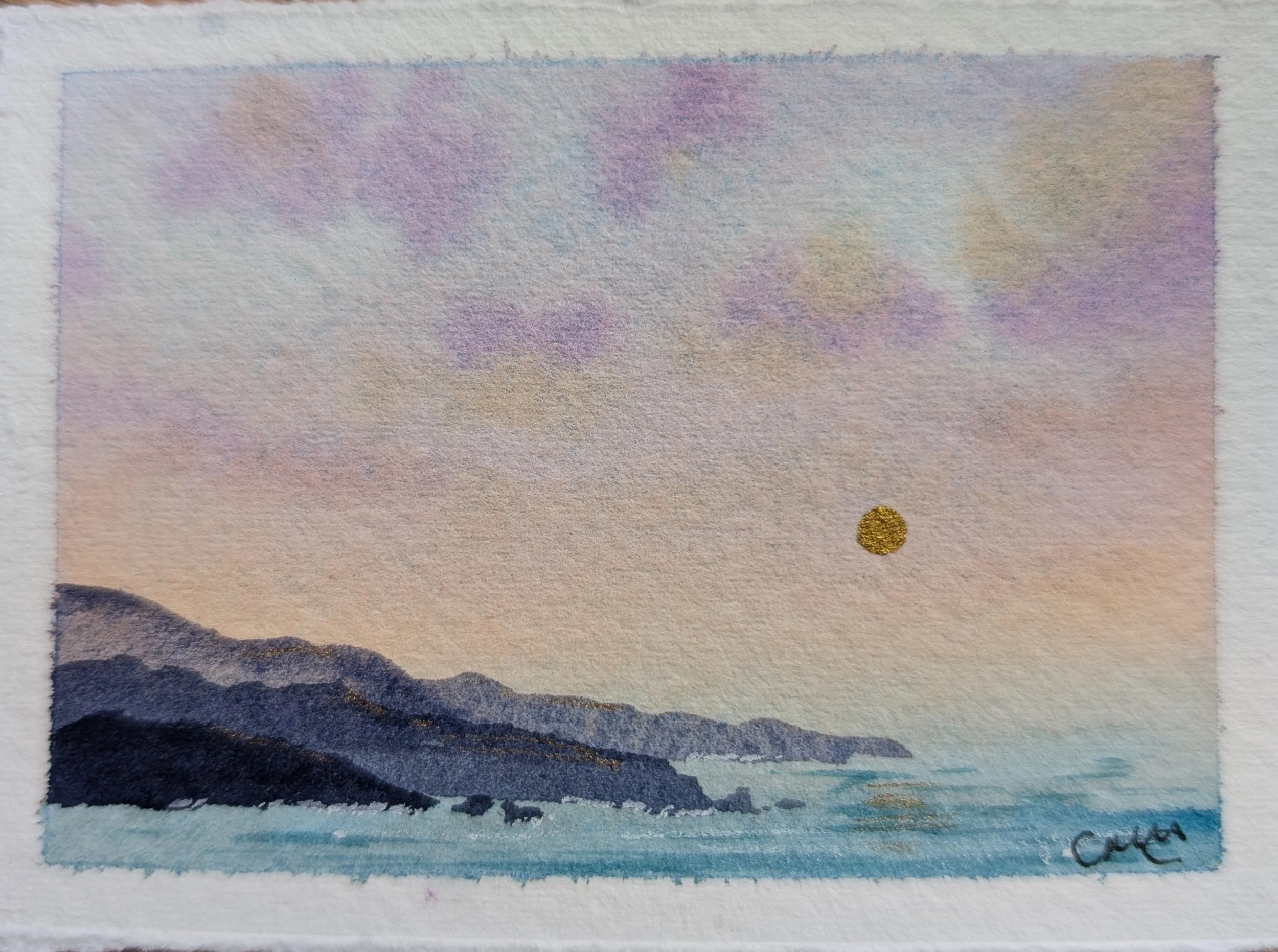 A watercolor painting of a landscape, featuring a dark mountain range in the foreground, a pale sky with soft pastel colors, and a small golden sun or moon near the horizon.